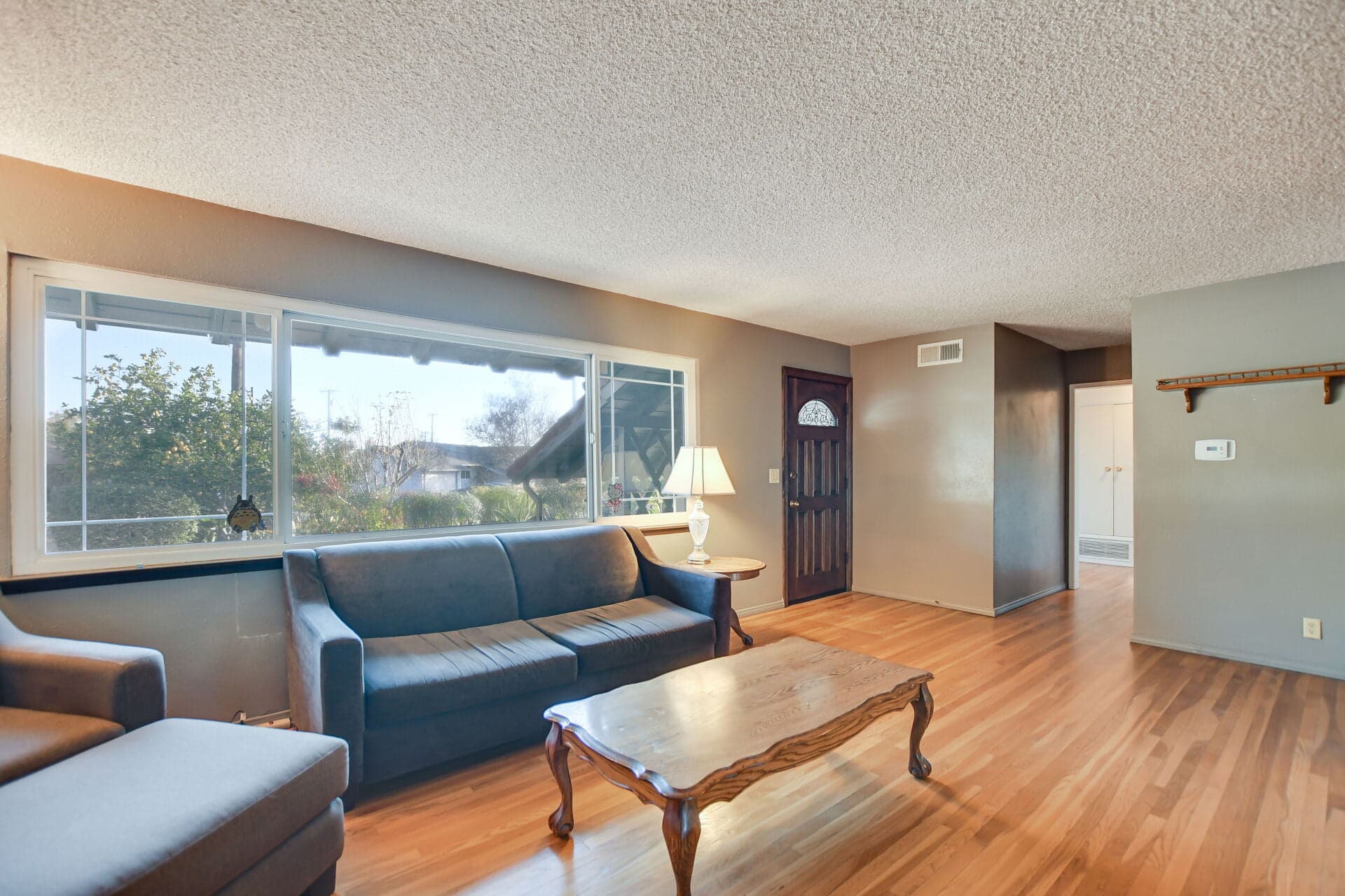 Bright living room with hardwood floors in a Claremont home