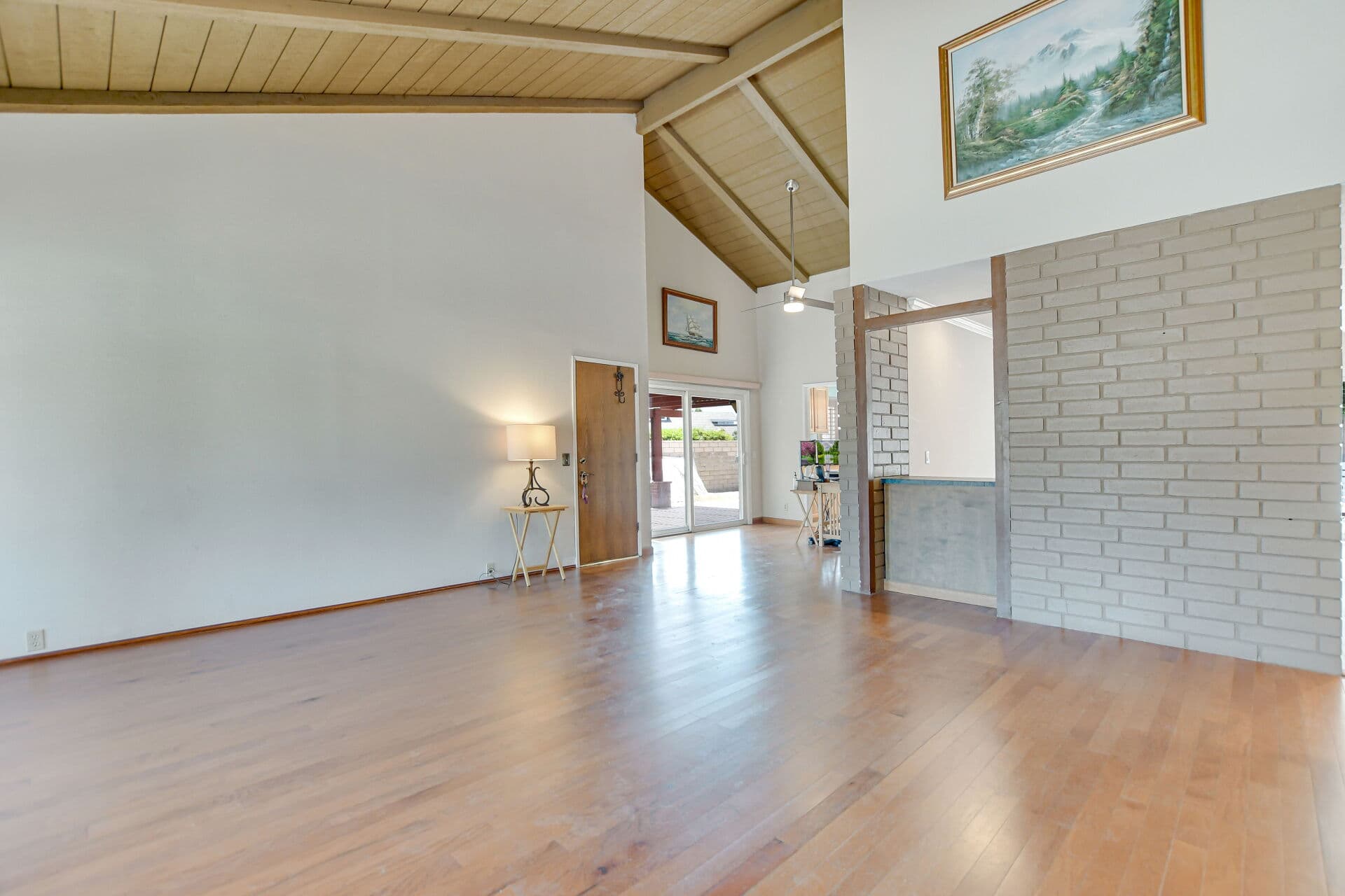 Vaulted living room looking toward the front entry of a Claremont home, where buyers finally receive the keys