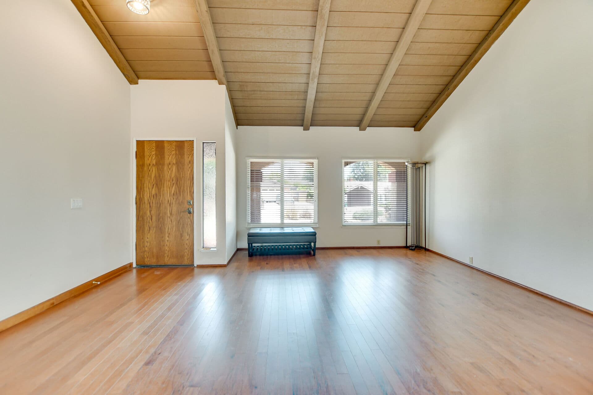 Empty vaulted-ceiling Claremont living room ready for moving day