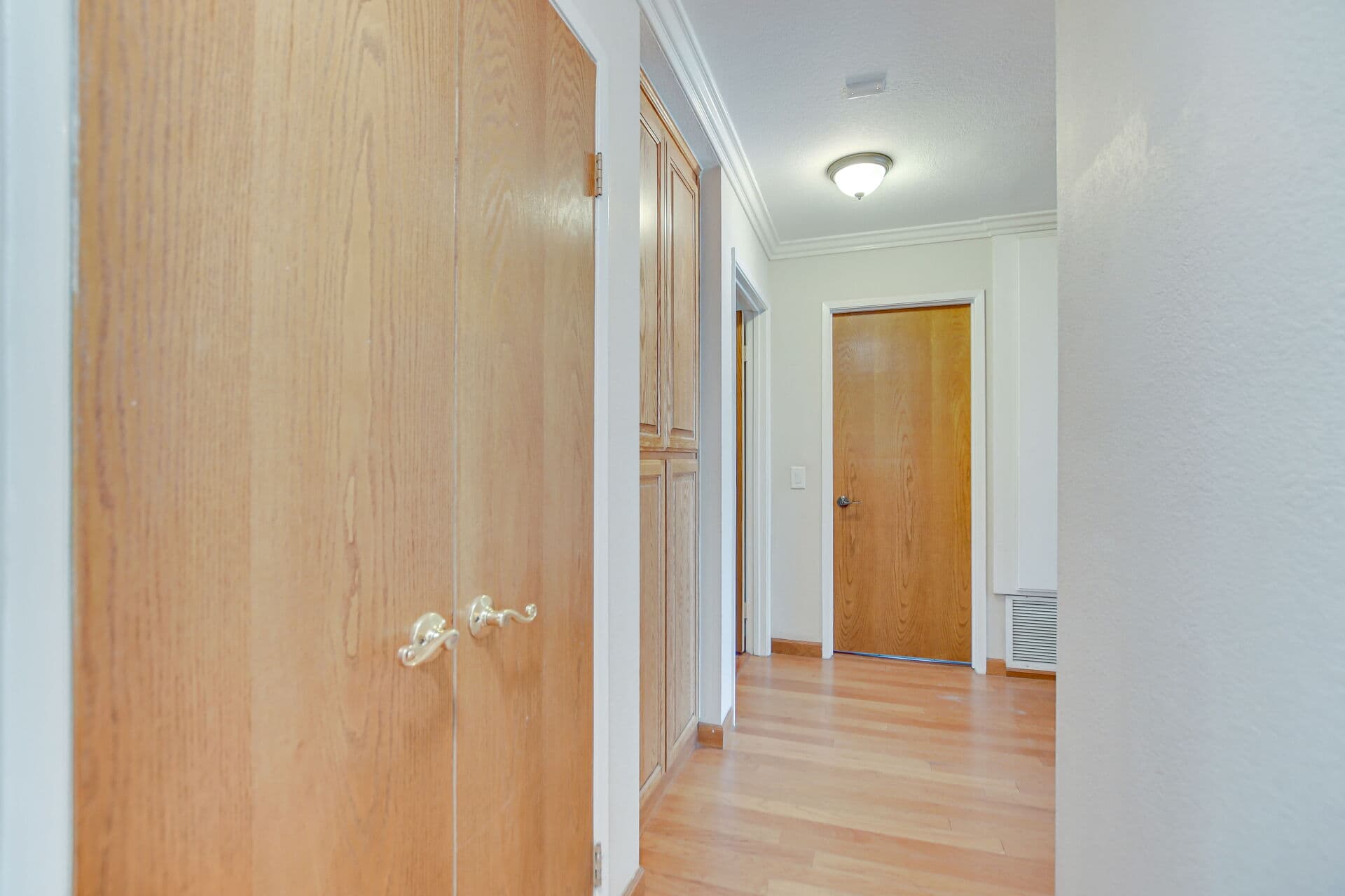 Oak-doored hallway showing the old bones of a Claremont house