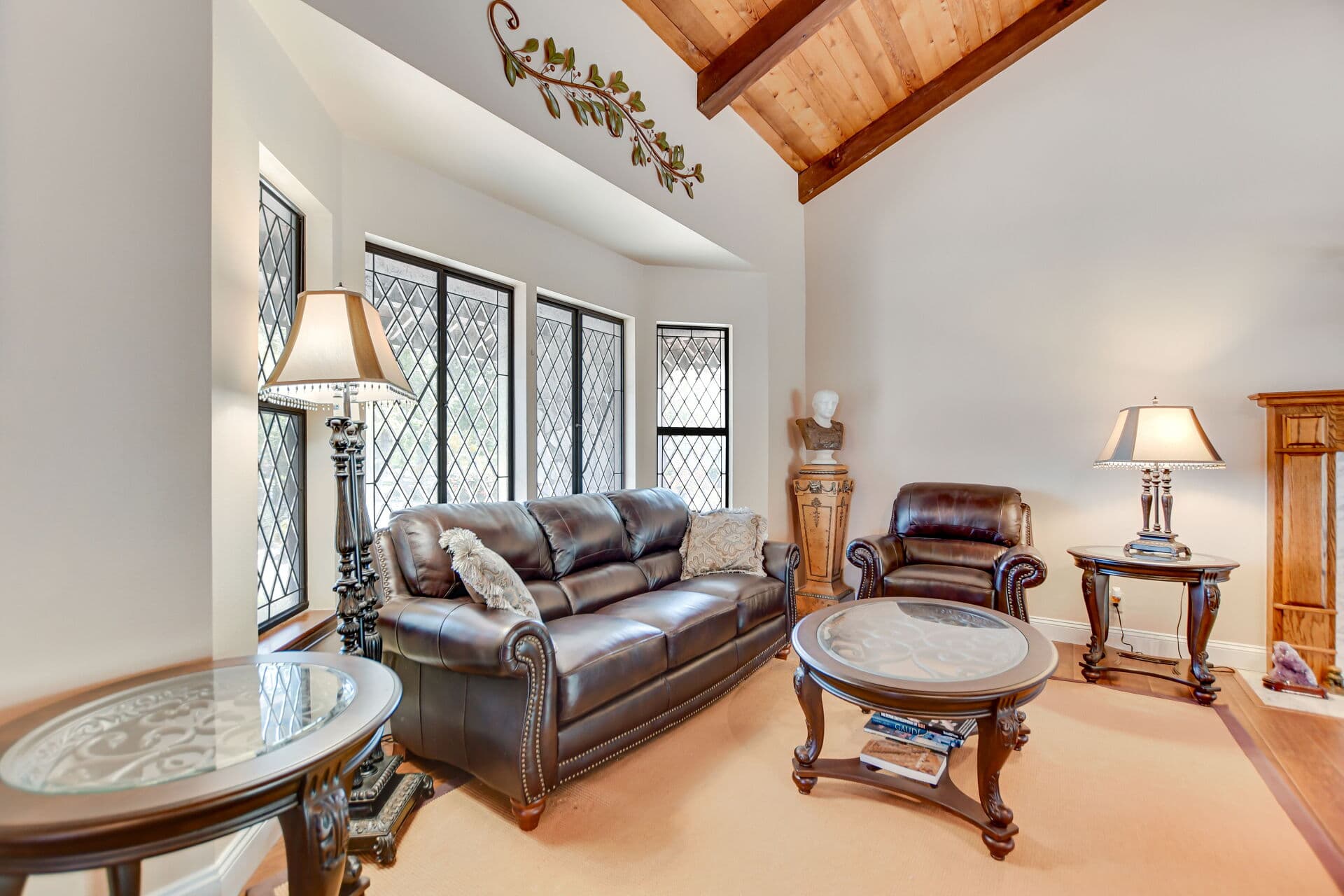 Formal living room with leaded bay windows staged for showing in Claremont