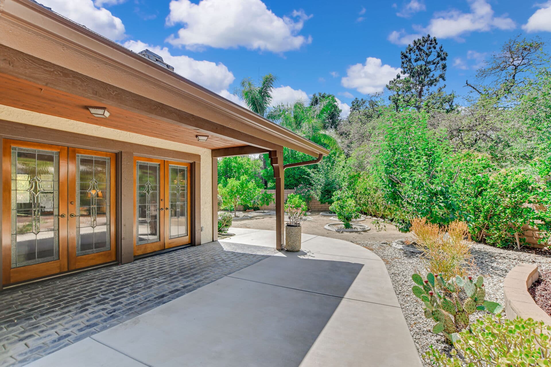 Covered rear patio with beveled-glass French doors at a Claremont home