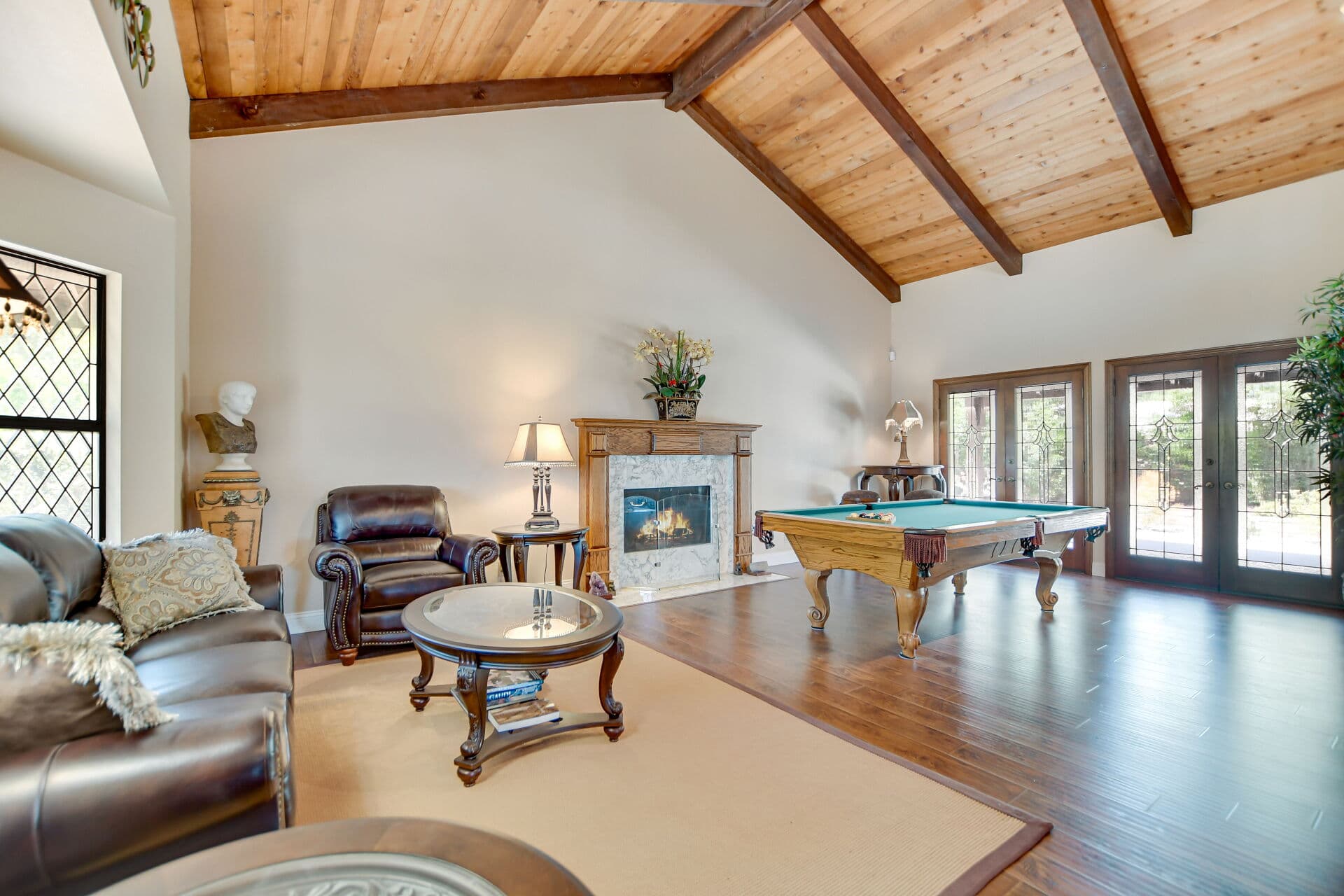Great room with leather seating and bay windows in a Claremont home