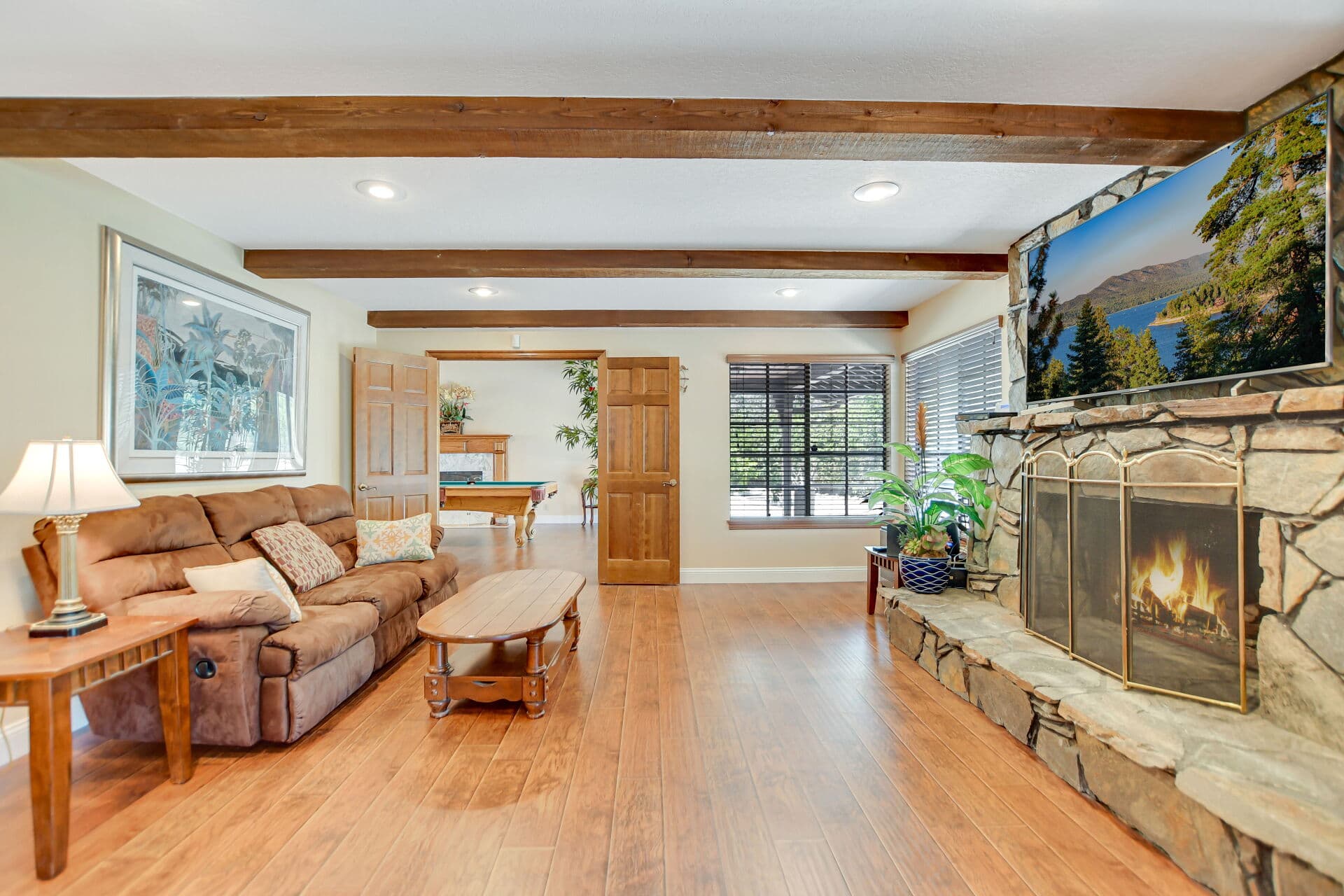Family room with stone fireplace in a Claremont home