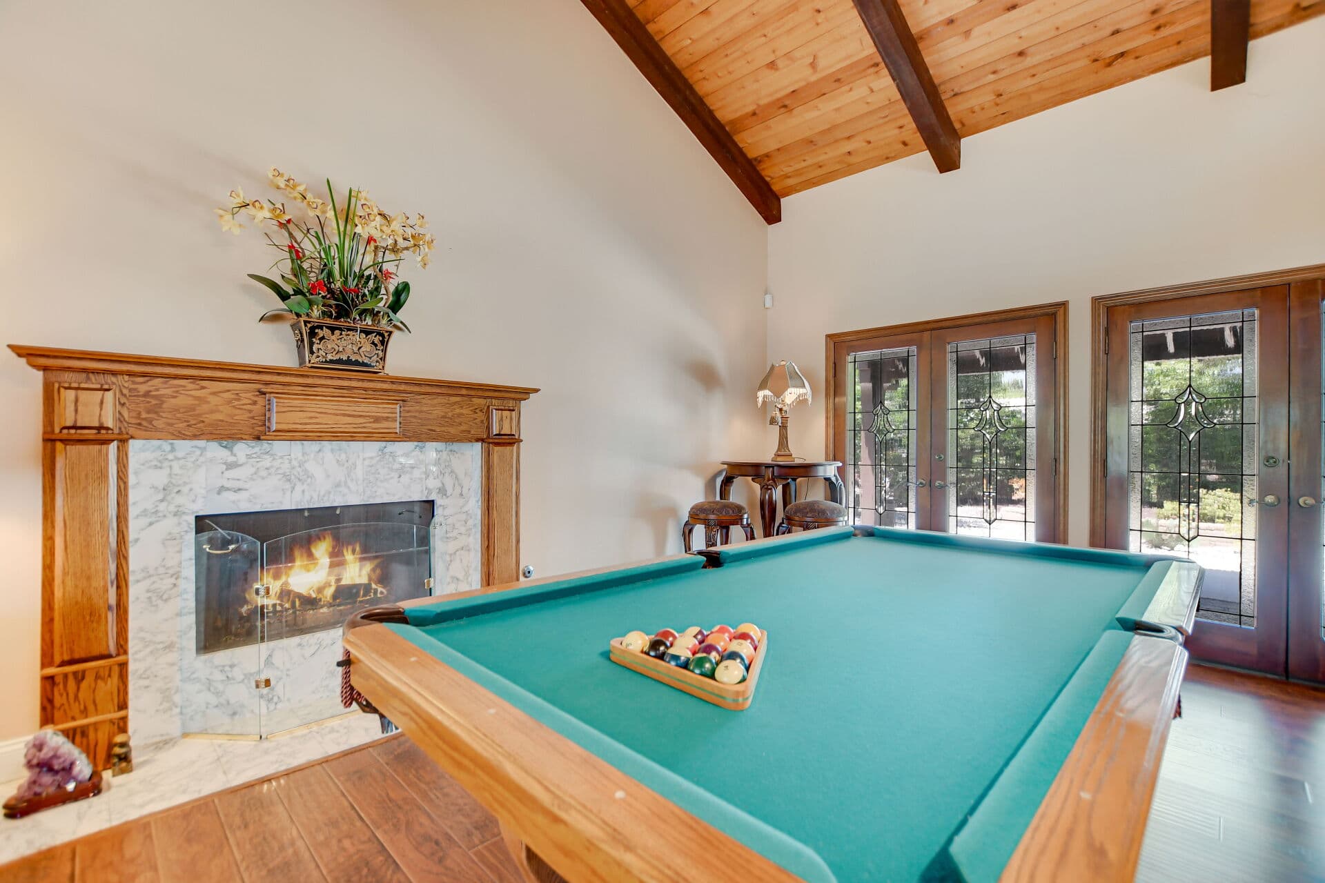 Billiards room with marble fireplace in a Claremont home