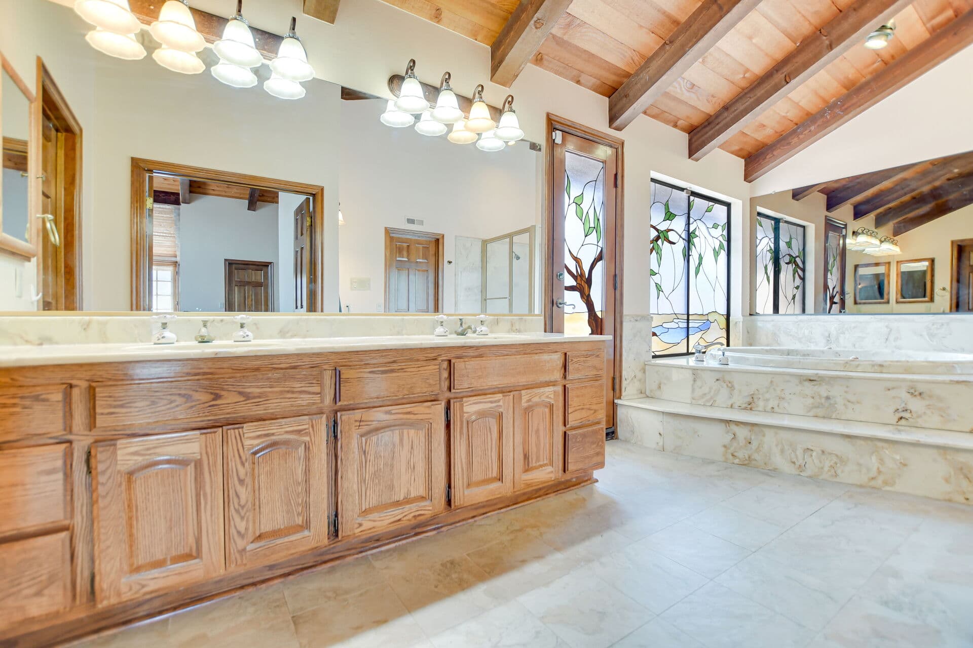 Primary bathroom with double oak vanity in a Claremont home