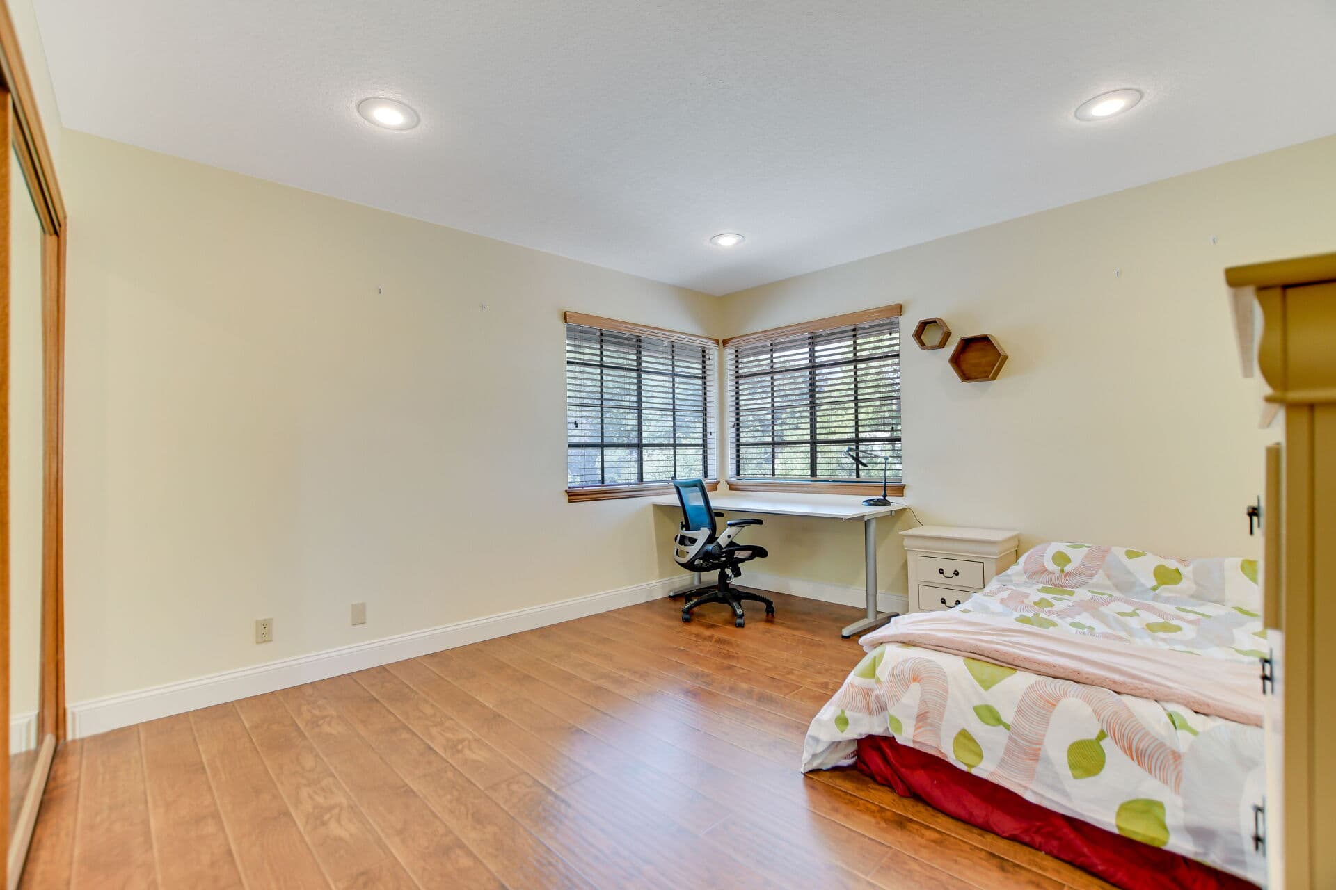 Secondary bedroom with corner windows in a Claremont home