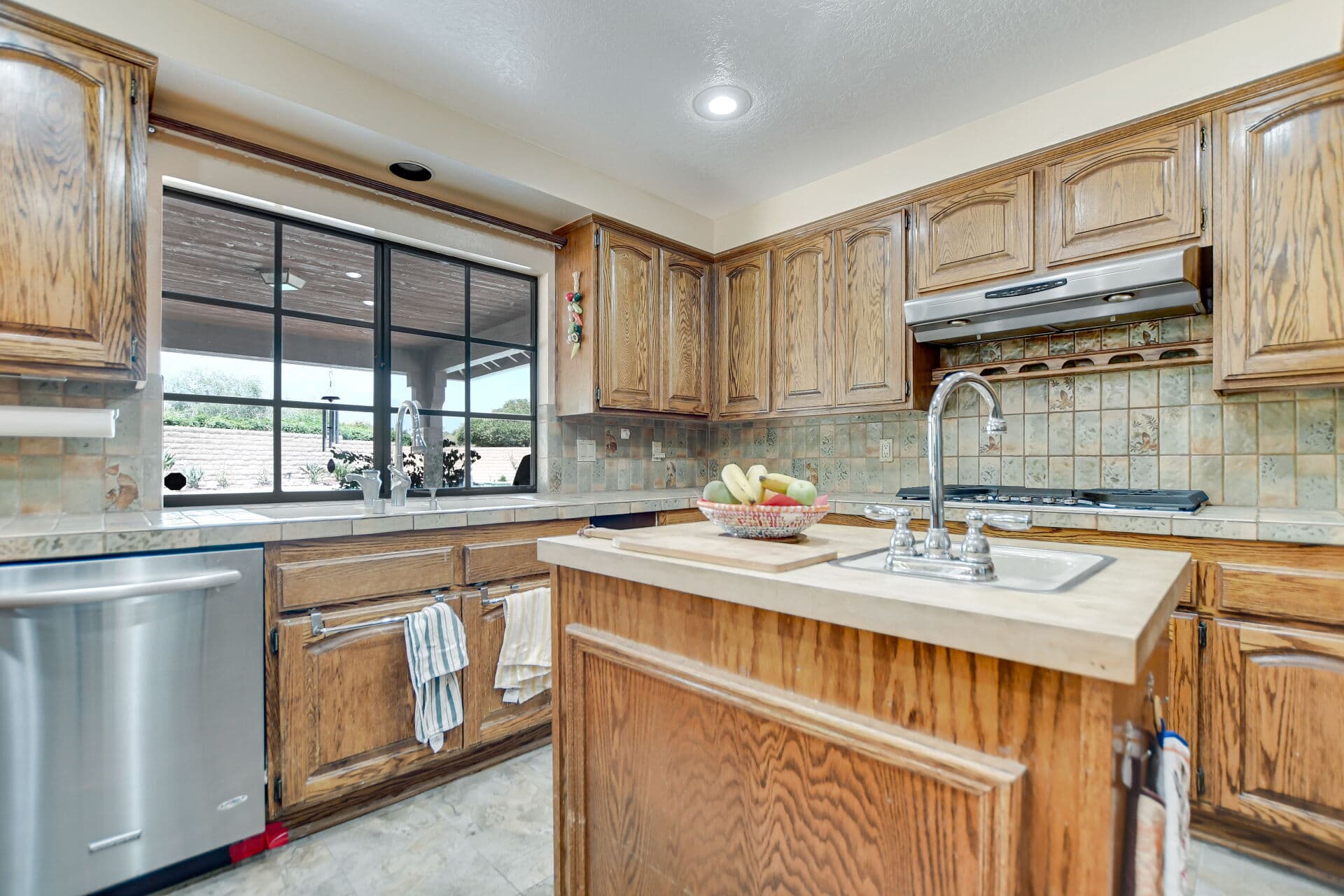 Kitchen with island and window over the sink in a Claremont home
