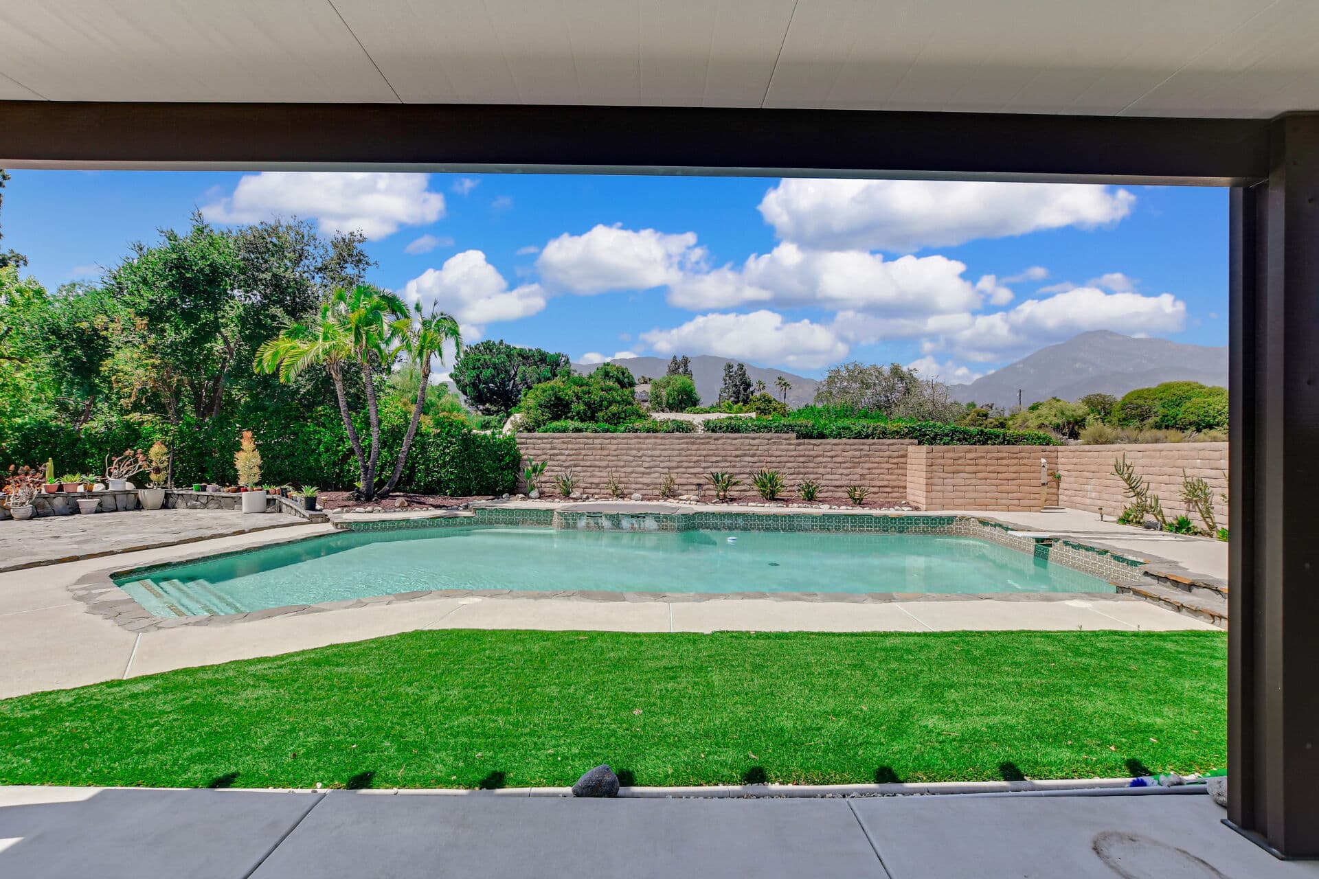 Claremont backyard pool and lawn with a clear view of the San Gabriel Mountains