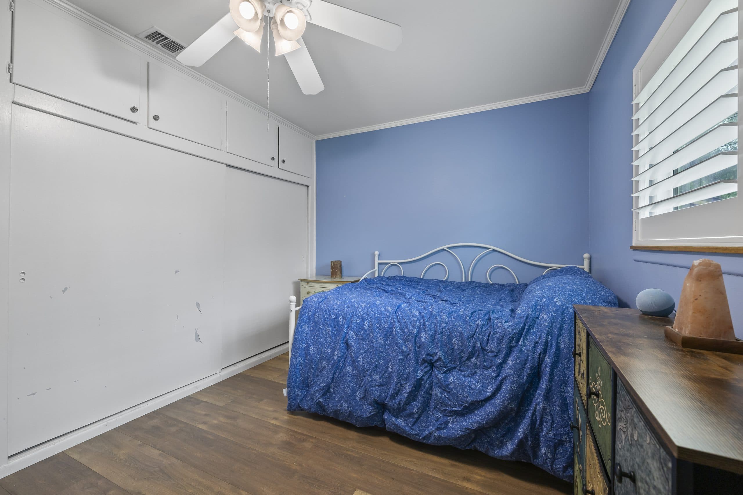 Bedroom with a wall of sliding closet doors in a Claremont home