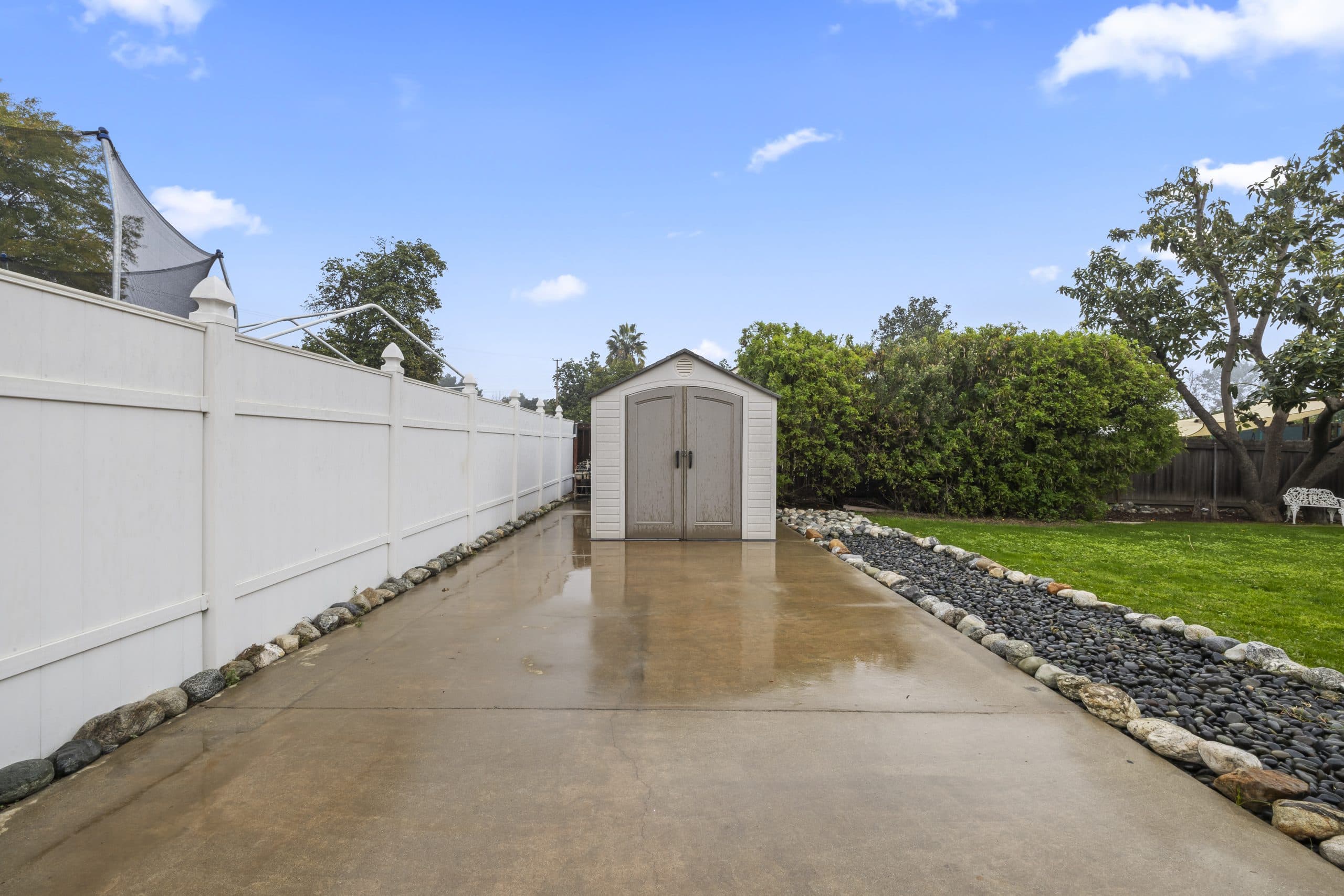 Side yard of a Claremont home along the fence line