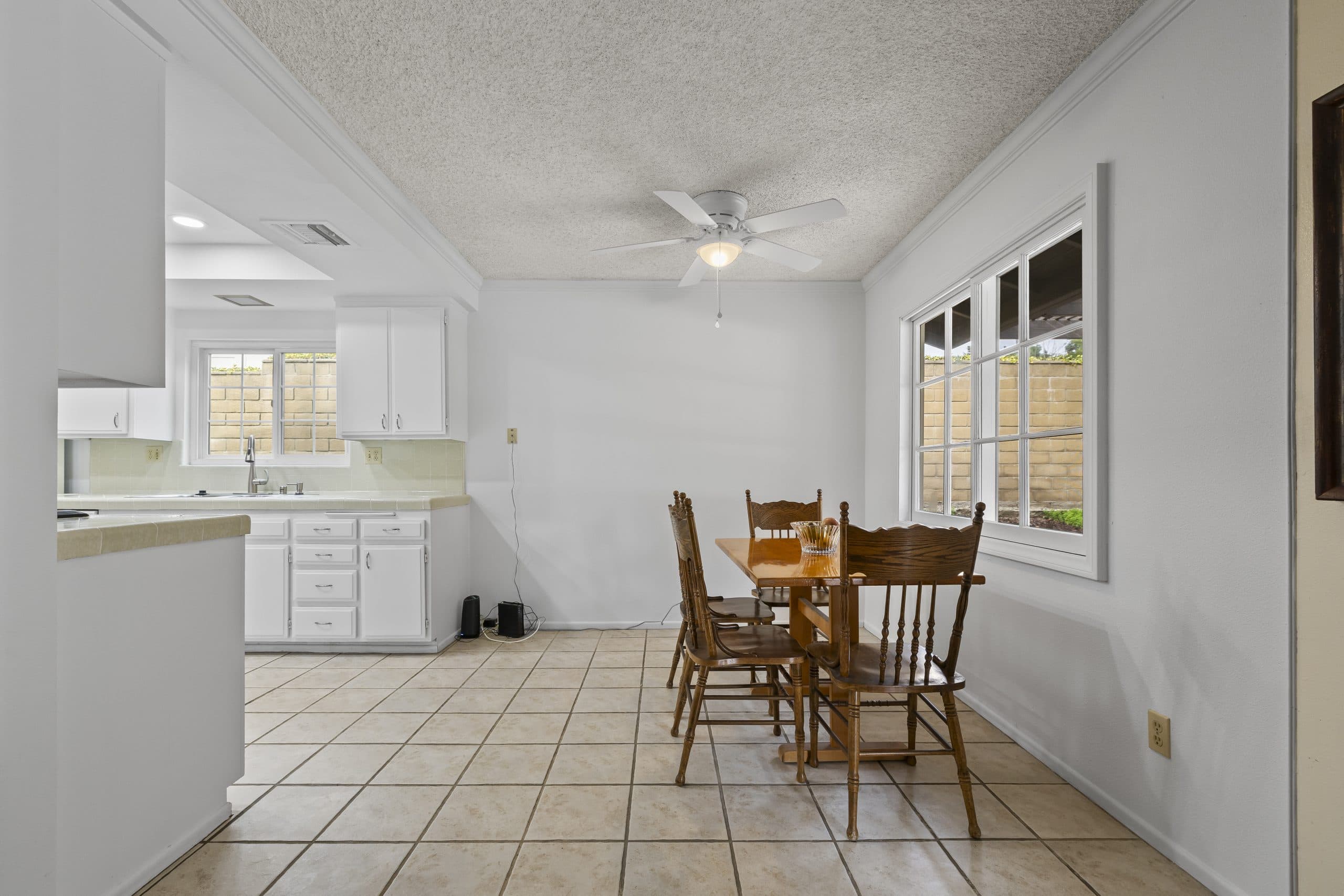 Dining table beside a bright window in a Claremont home