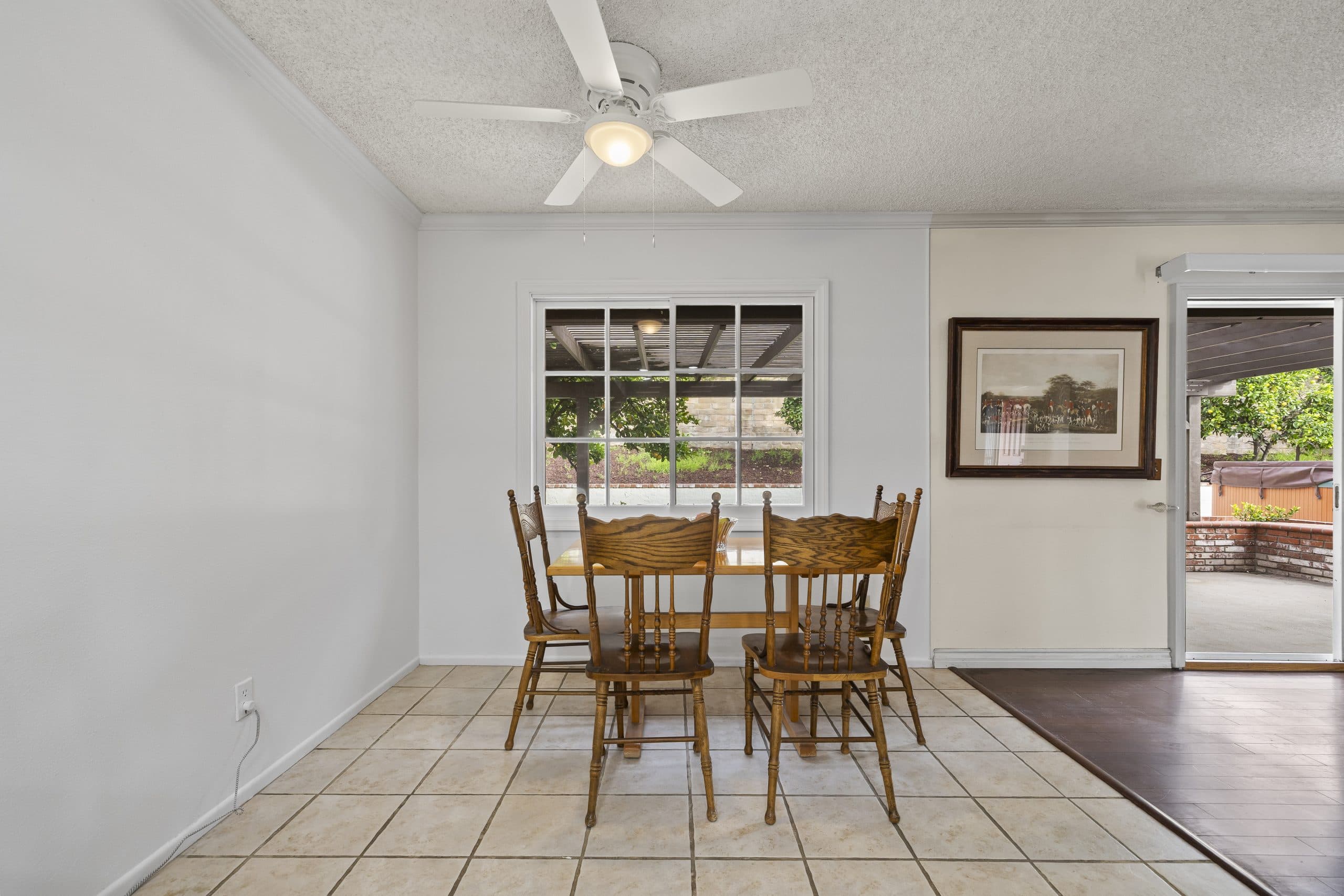 Bright dining nook with an oak table beside a window in a Claremont home