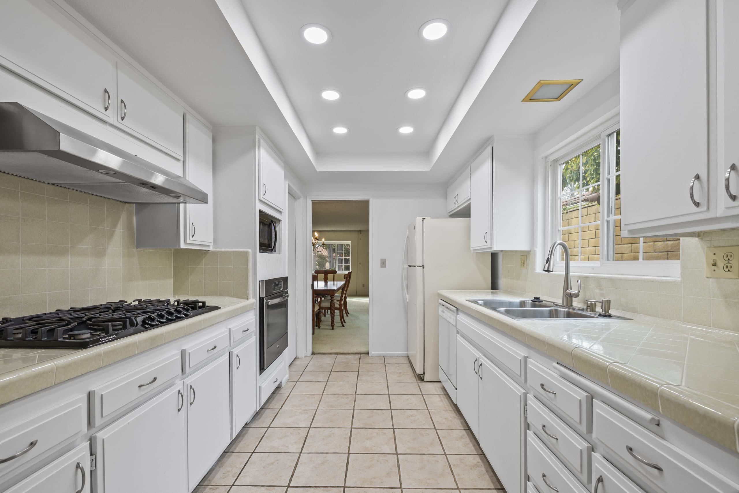 White galley kitchen with two parallel counters in a Claremont home