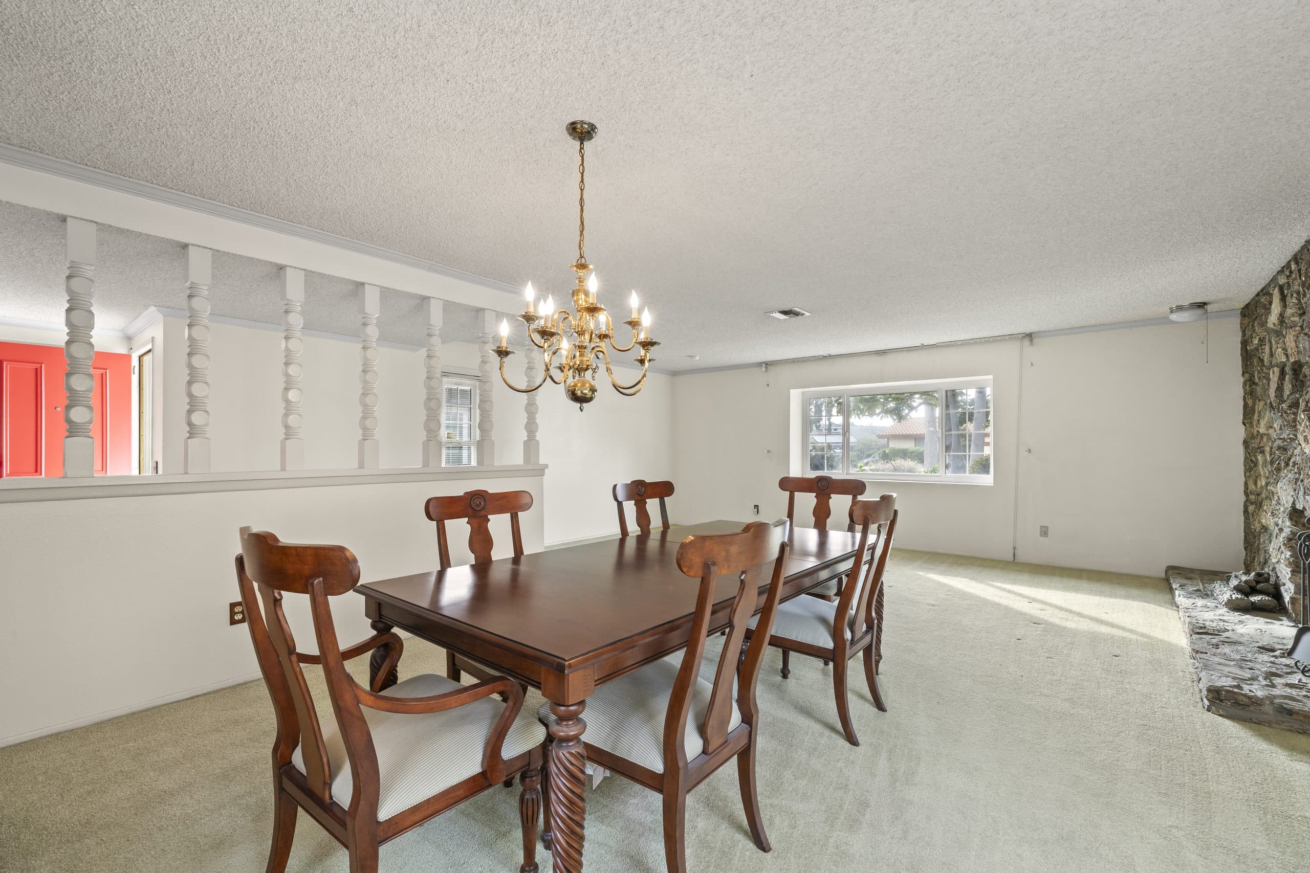 Formal dining table under a brass chandelier in a Claremont home