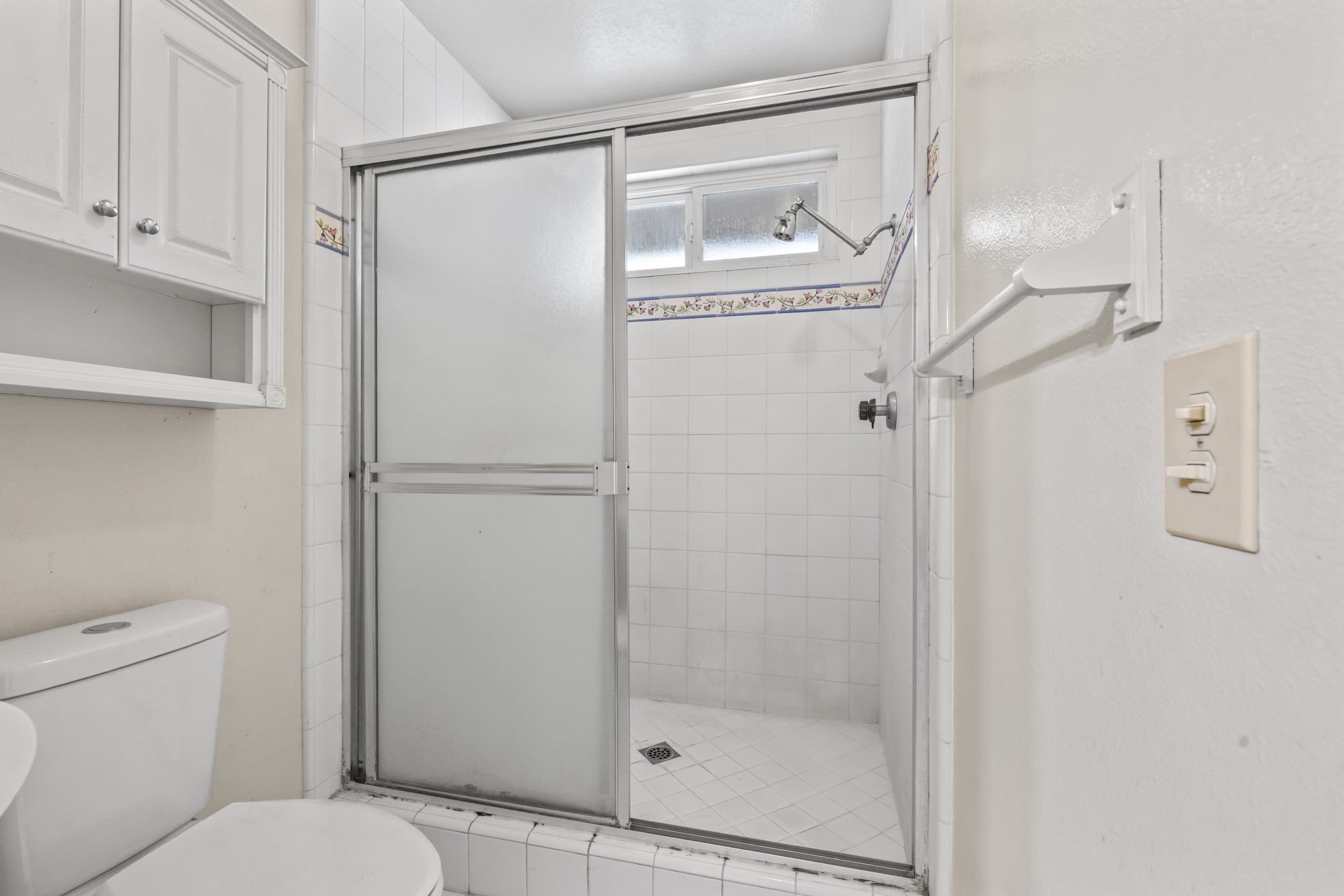Bathroom with shower stall and tile border in a Claremont home