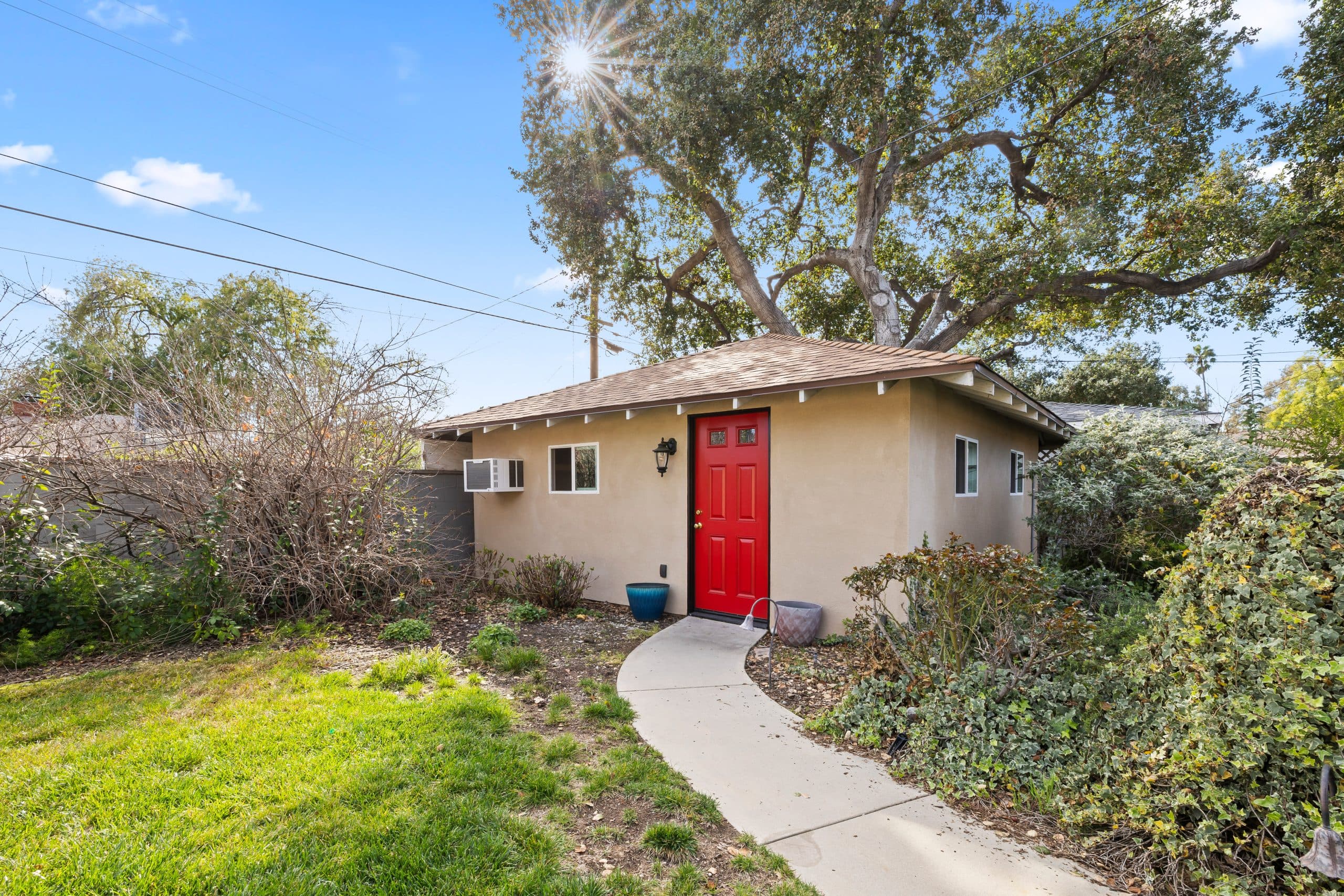 Backyard cottage with a red front door in Claremont