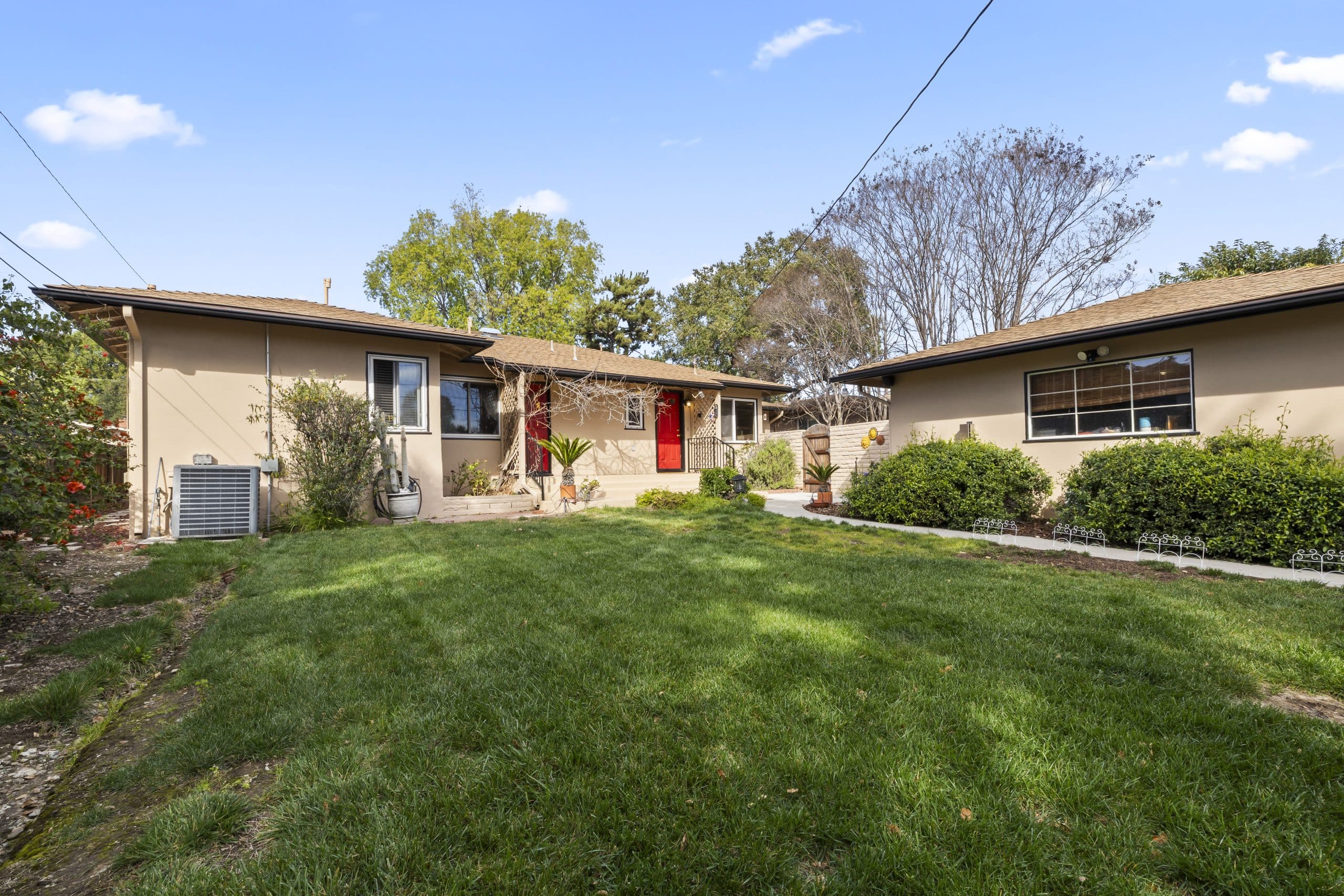 Single-story Claremont home under mature trees with a broad front lawn