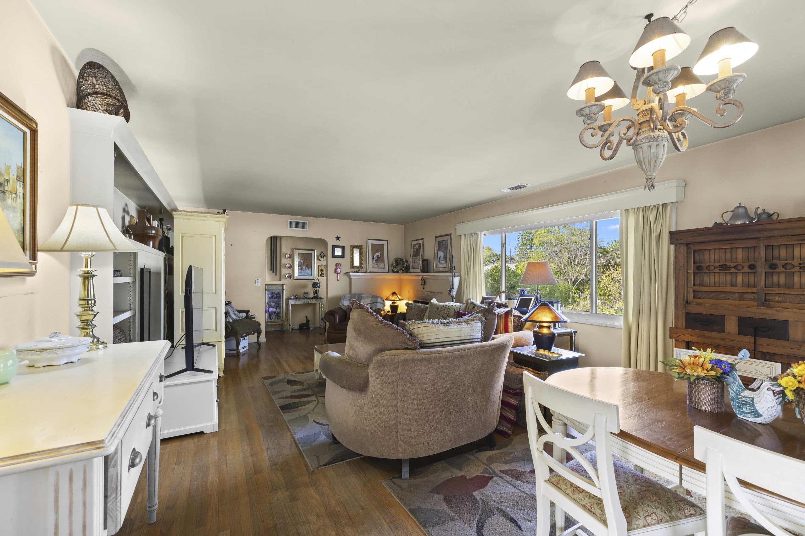 Long-established Claremont living room with chandelier and garden view