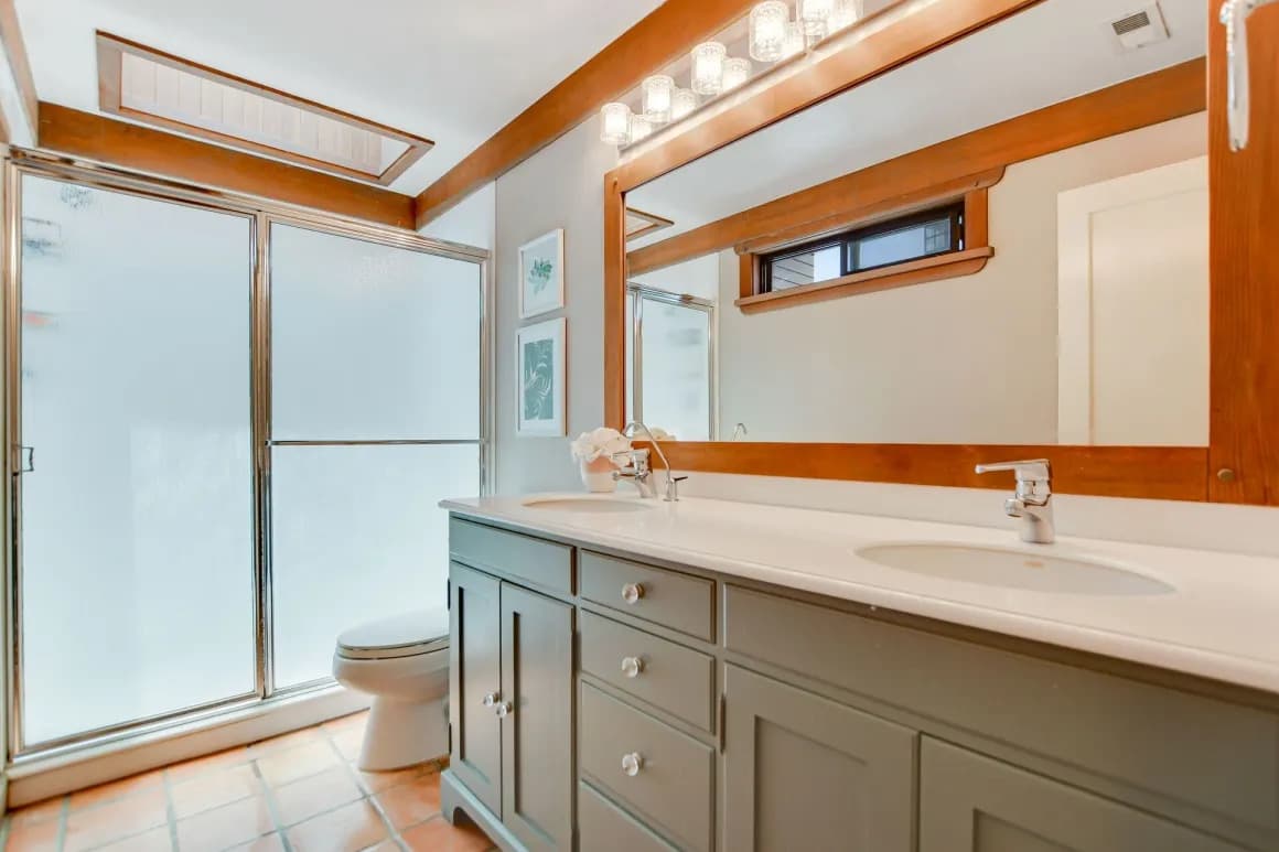 Bathroom with a double vanity and wood trim in a Claremont home