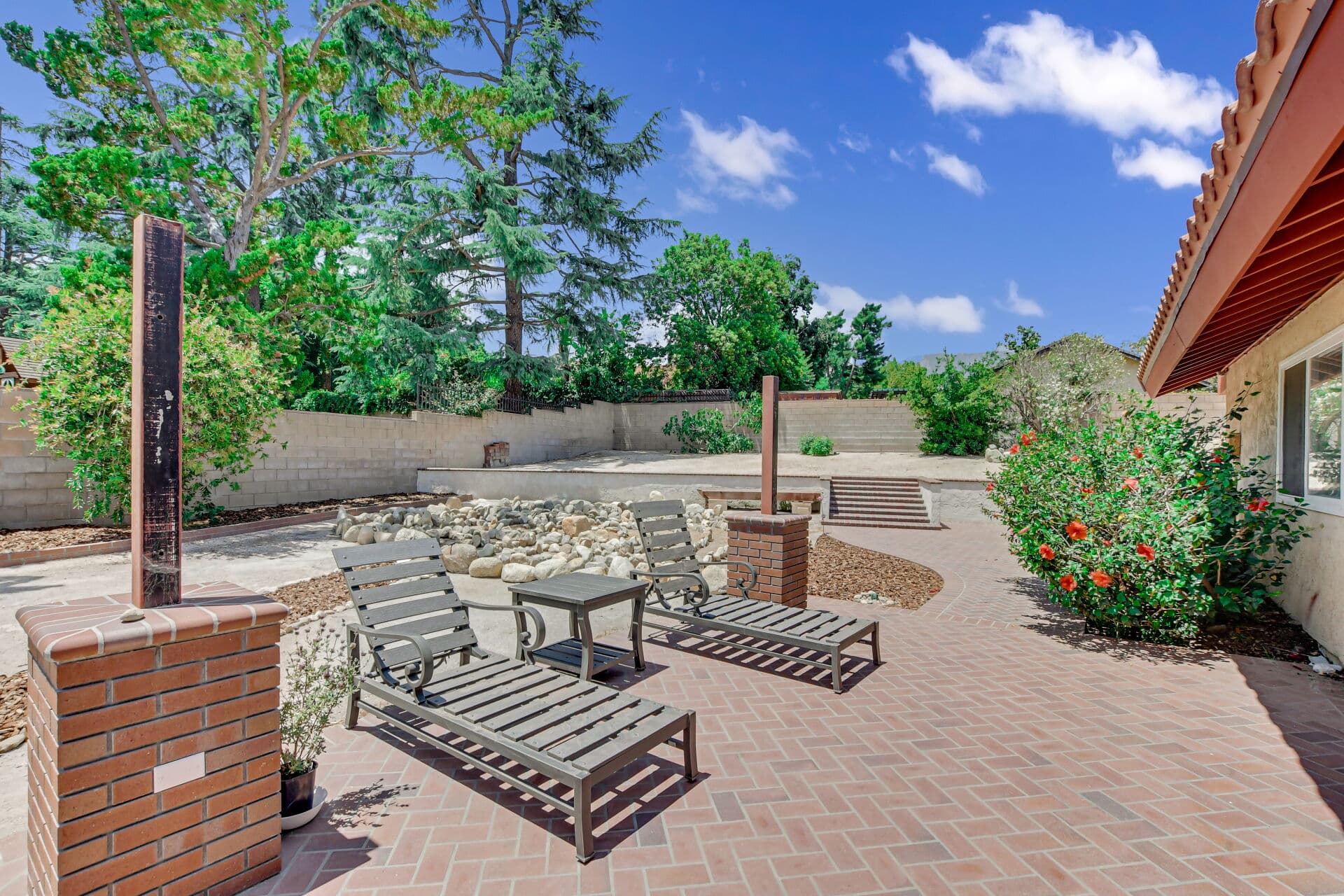 Backyard brick patio and rock garden of a Claremont home