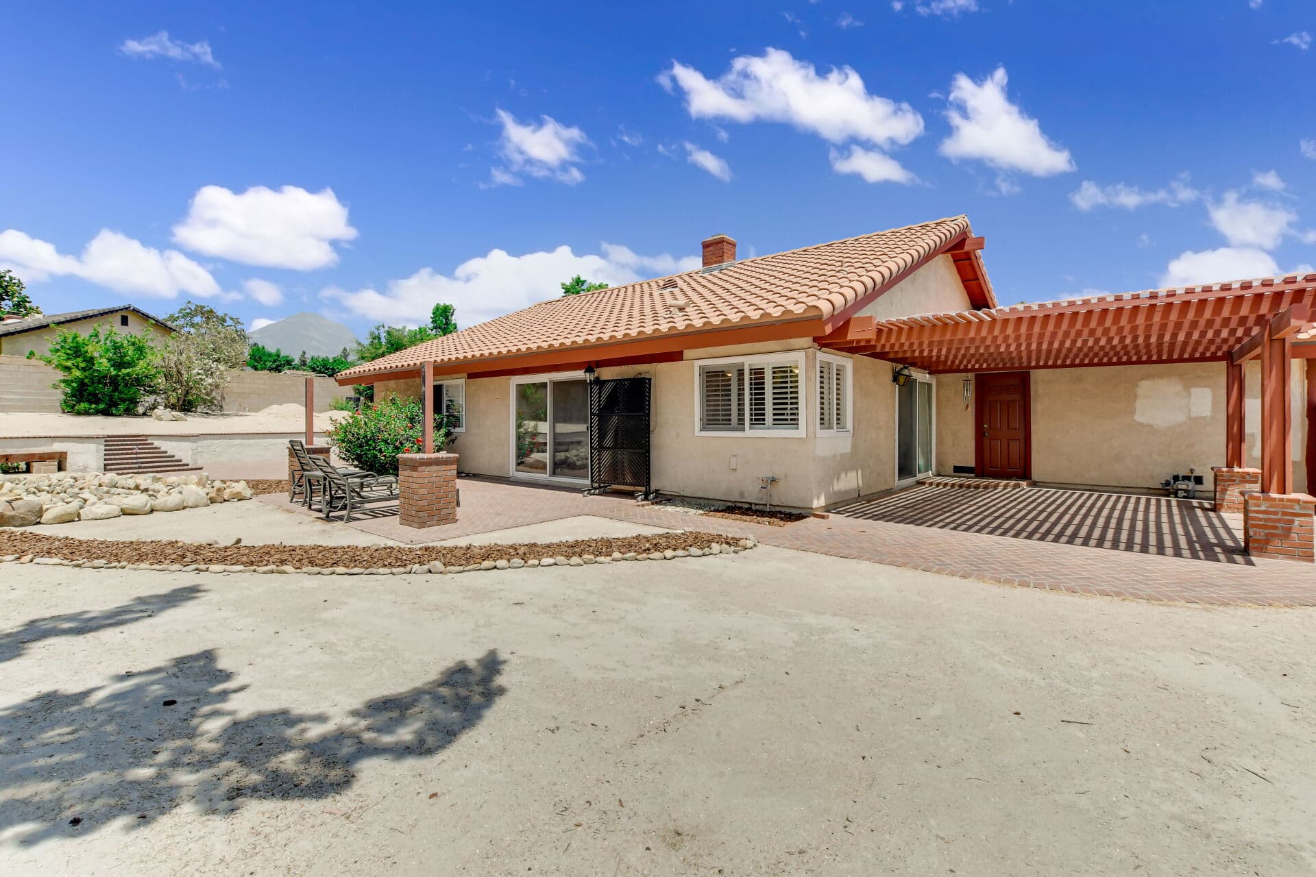 Character Spanish-style Claremont home with tiled roof and brick courtyard