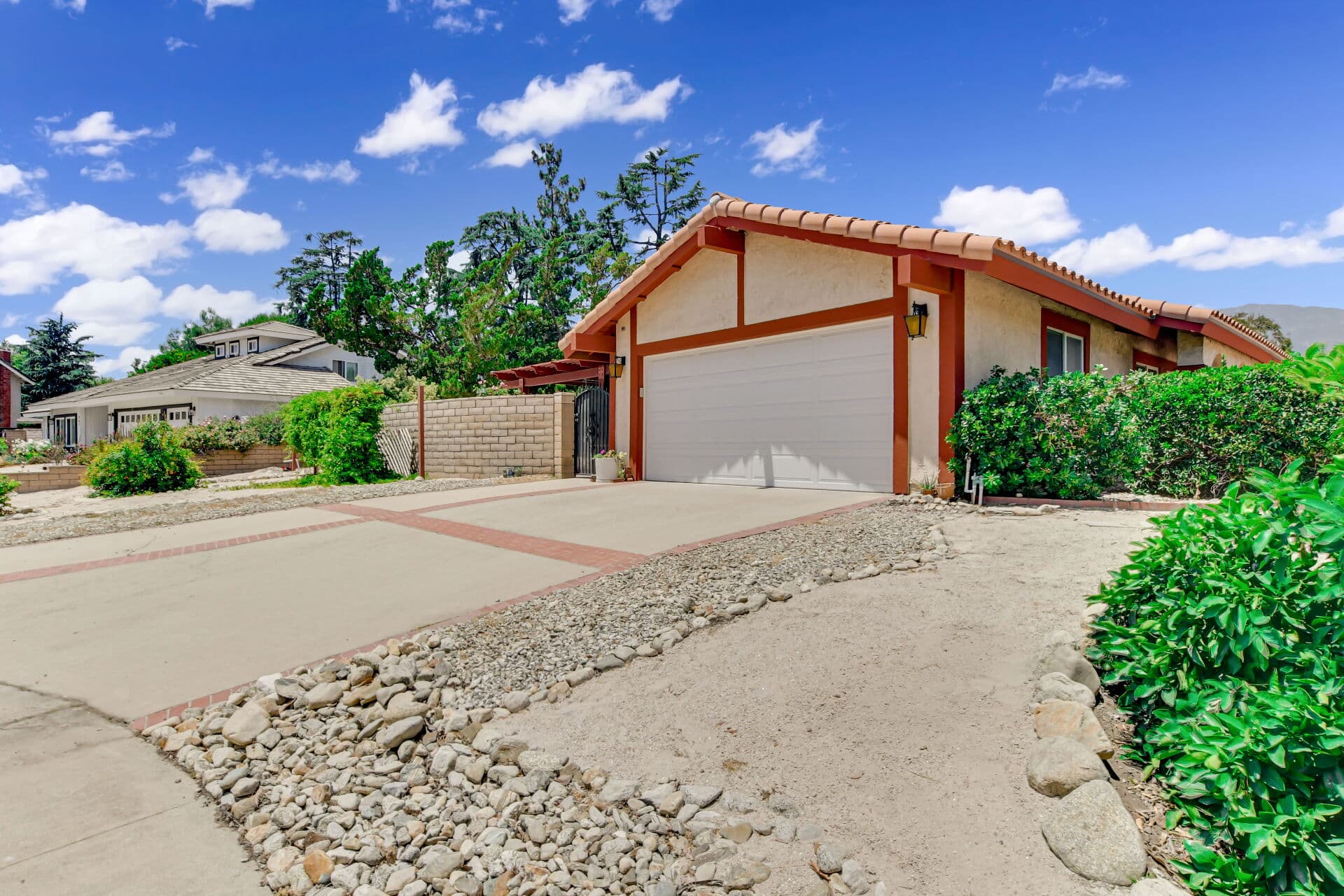 Single-story Claremont home with tile roof and mountain backdrop