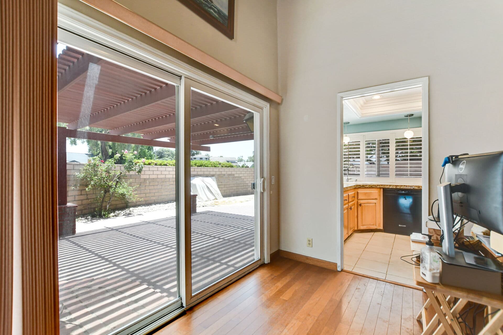 Sliding glass door in a Claremont home opening to a covered patio, bridging one living space to the next