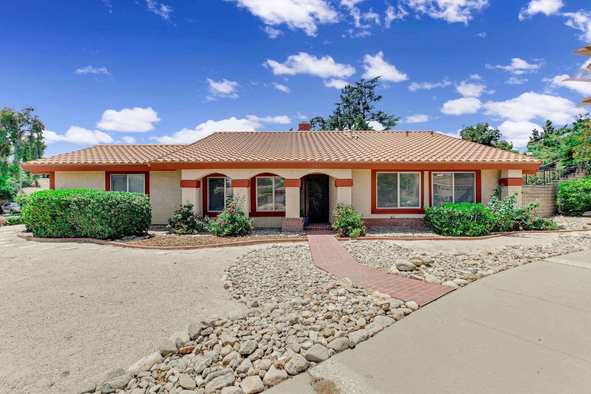 Single-story ranch home spread across a wide Claremont lot with a circular driveway