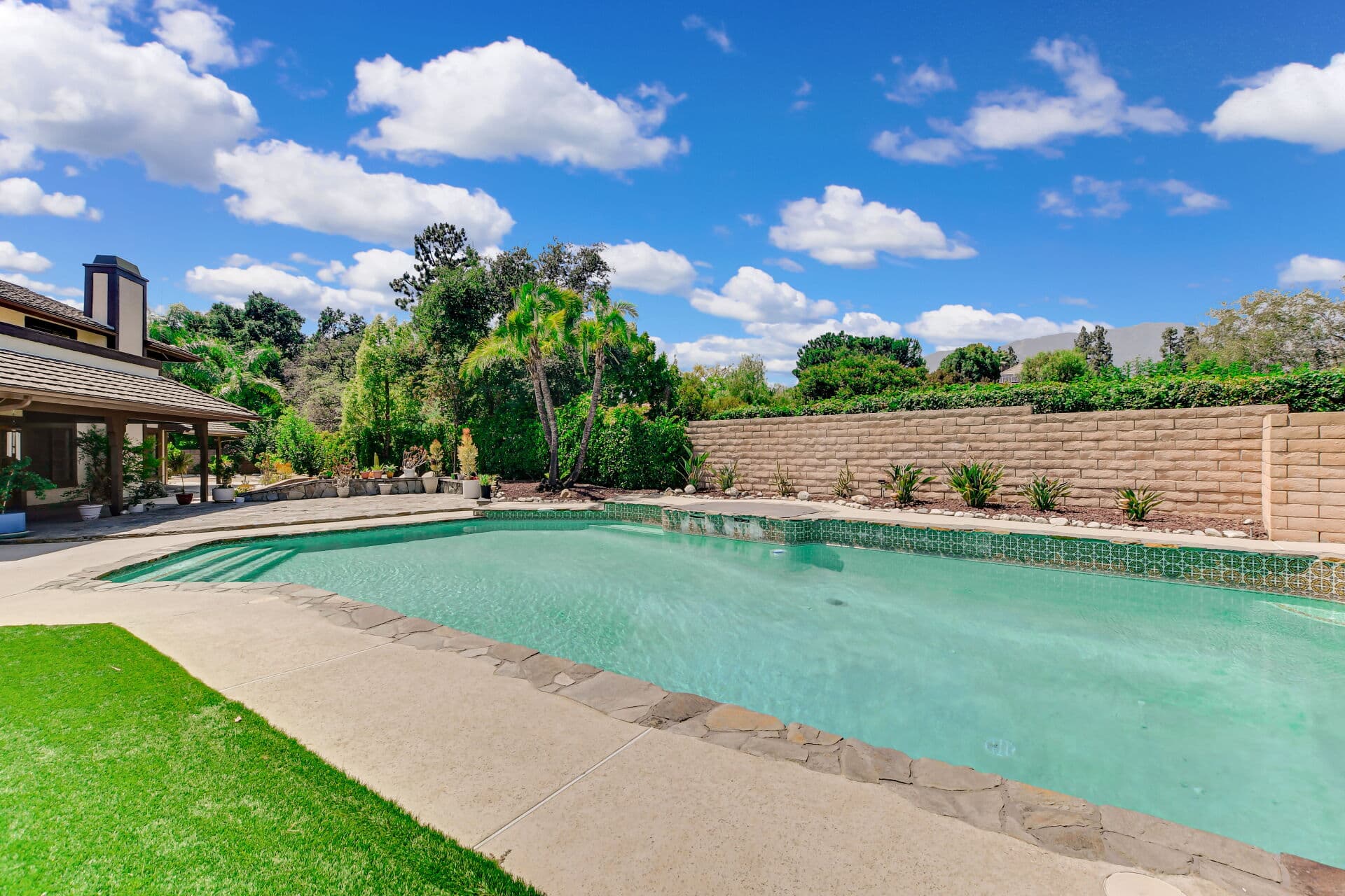 Bright green lawn and fresh garden beds in a Claremont backyard in spring