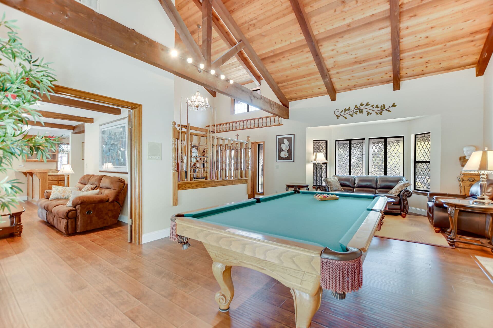 Vaulted exposed-beam great room with leaded windows in a character Claremont home