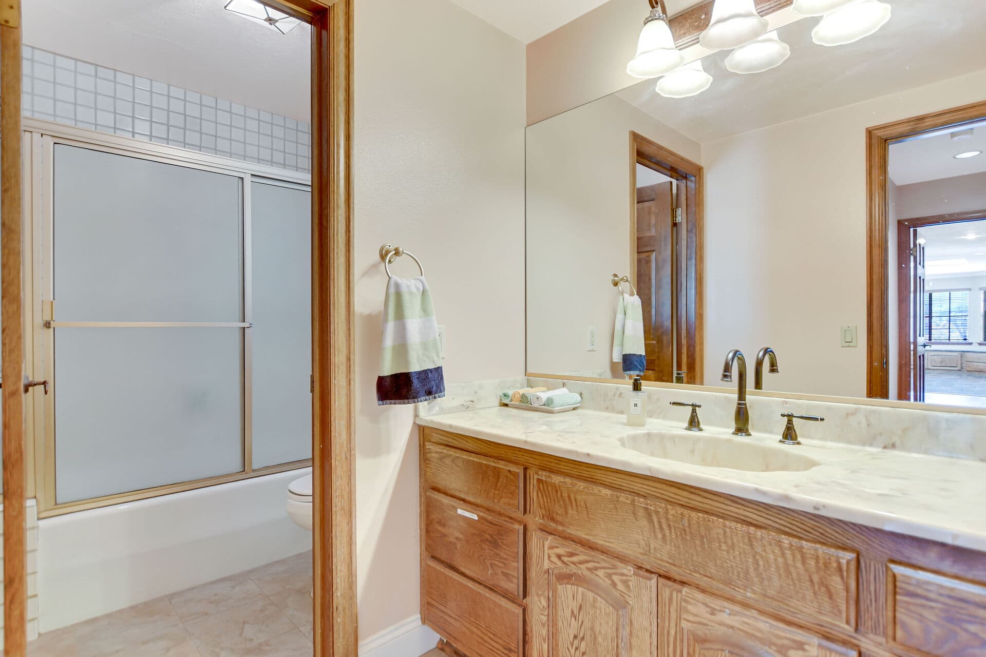 Bathroom vanity with a view to the tub in a Claremont home