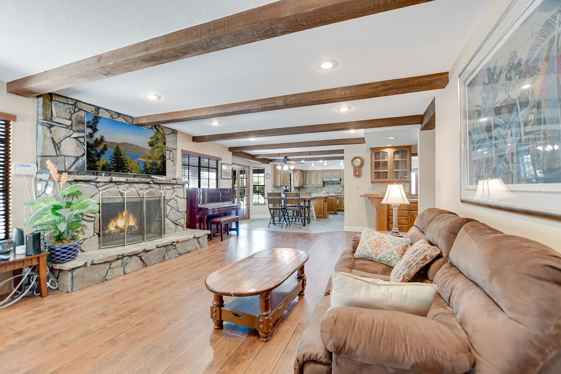 Family room with a floor-to-ceiling stone fireplace in a Claremont home