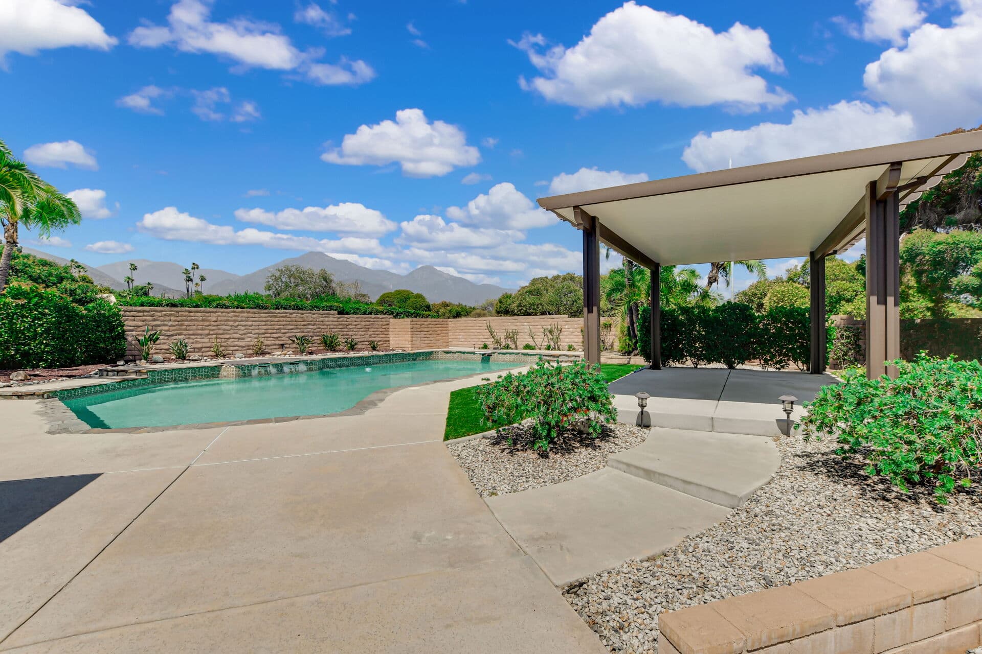 Pool and shade pavilion with a mountain view at a Claremont home