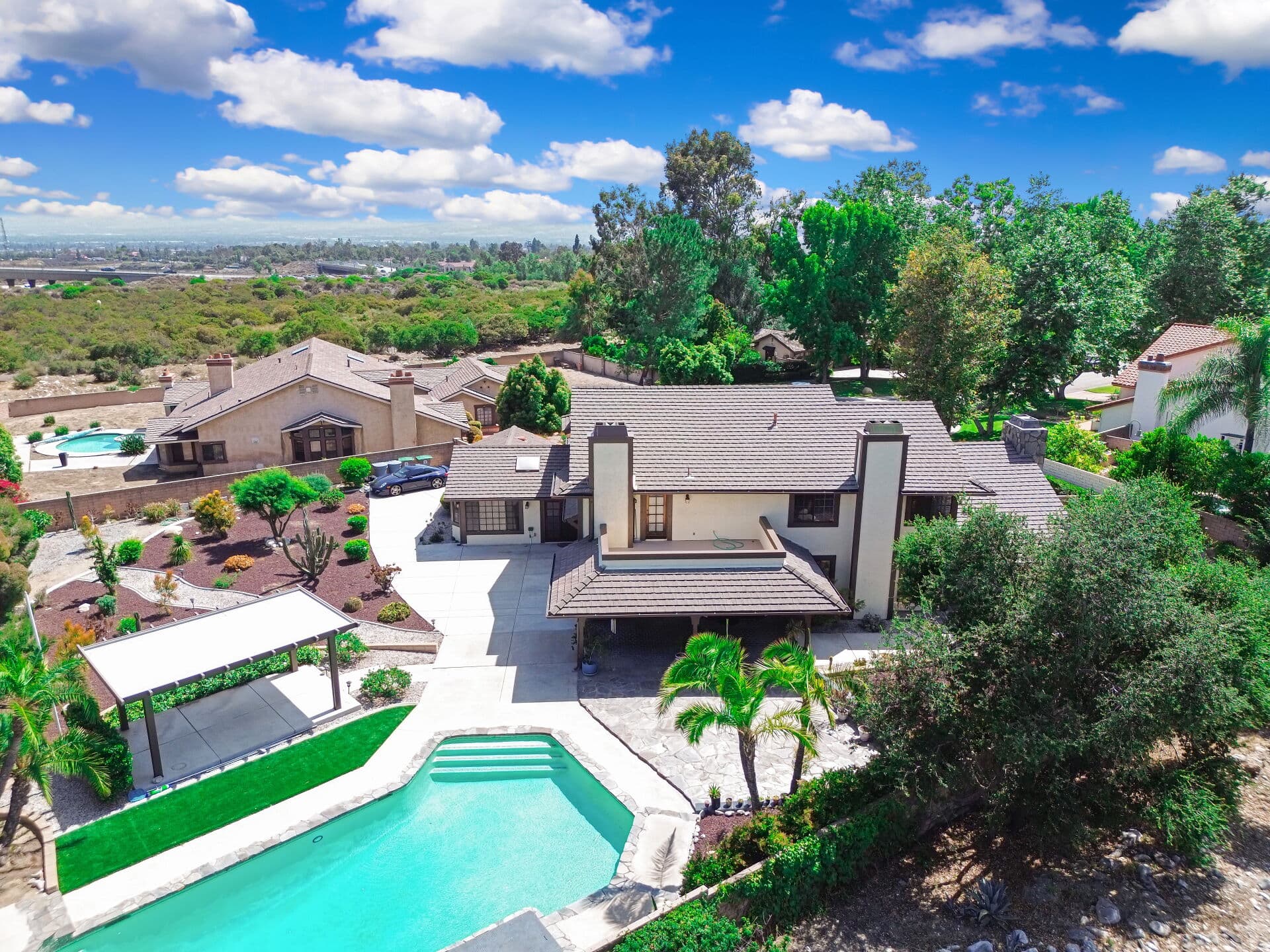 Aerial view of a Claremont home with its pool, driveway, and full lot visible, the whole-property perspective an appraiser evaluates on a site visit