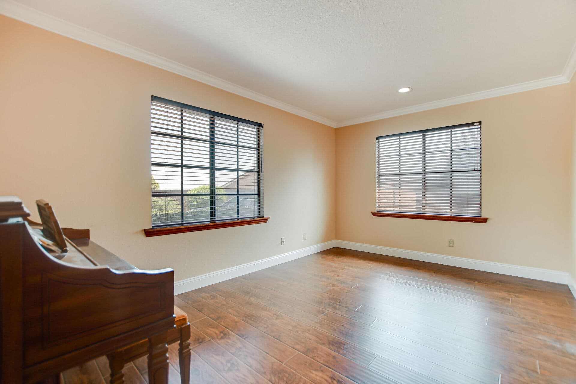 Claremont sitting room with an heirloom upright piano, the kind of furnishing an inherited estate passes down