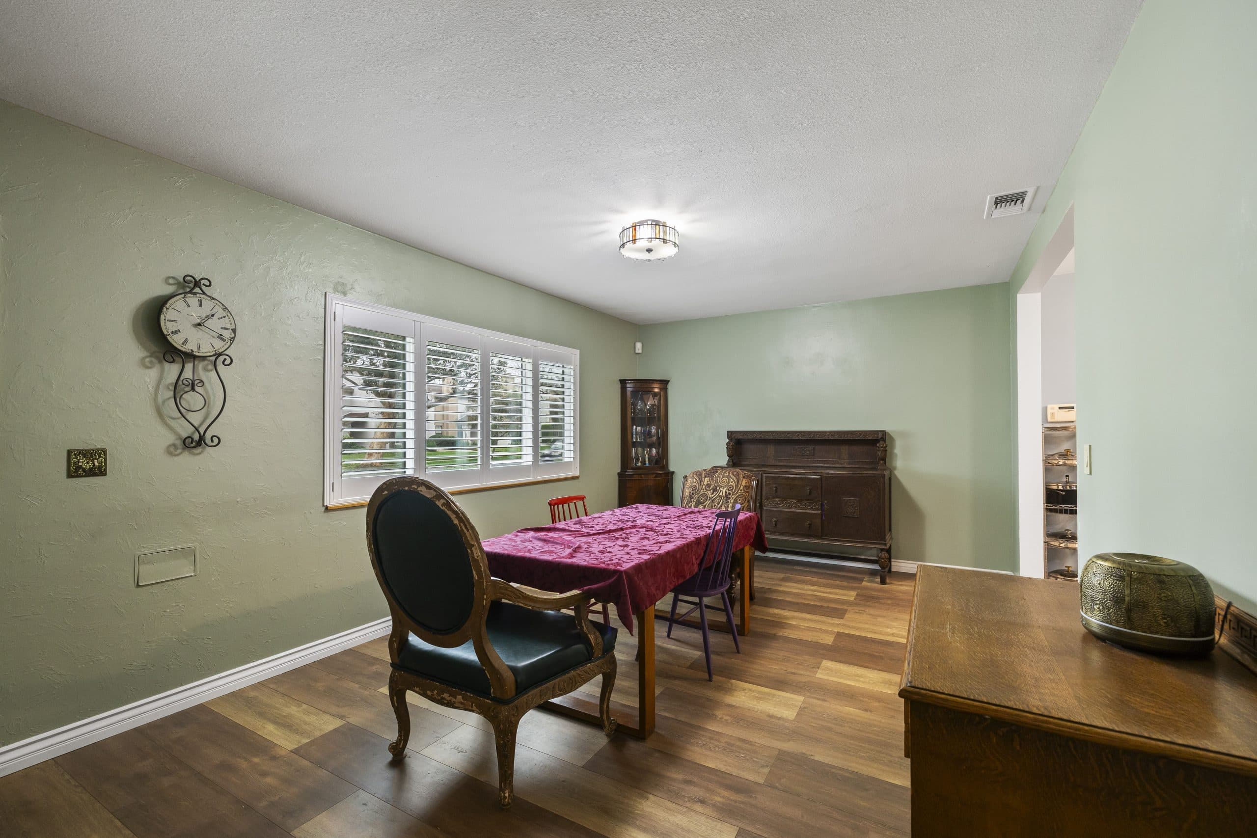 Claremont dining room with antique sideboard and wall clock