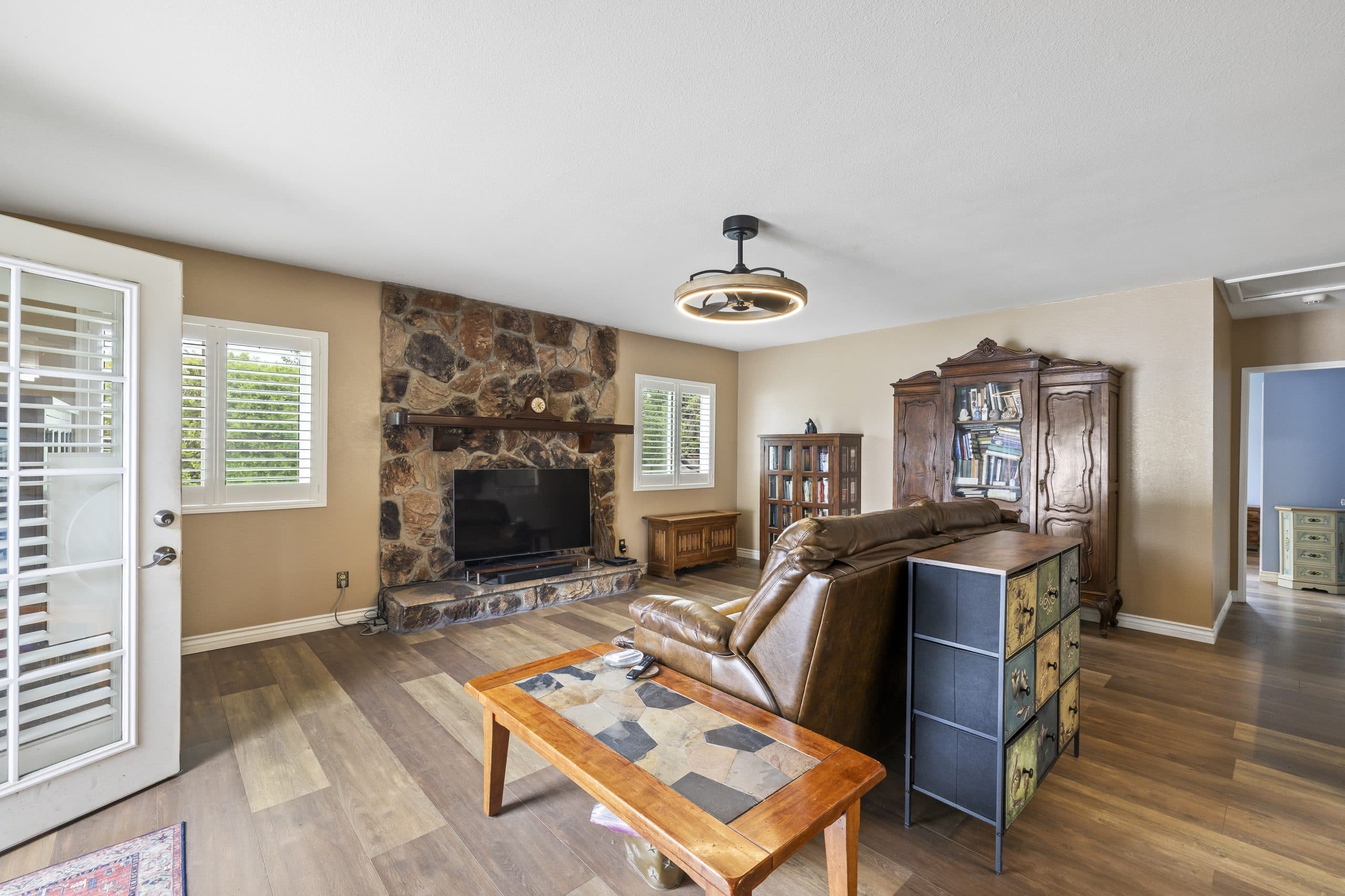 Stone-fireplace family room in an established Claremont home