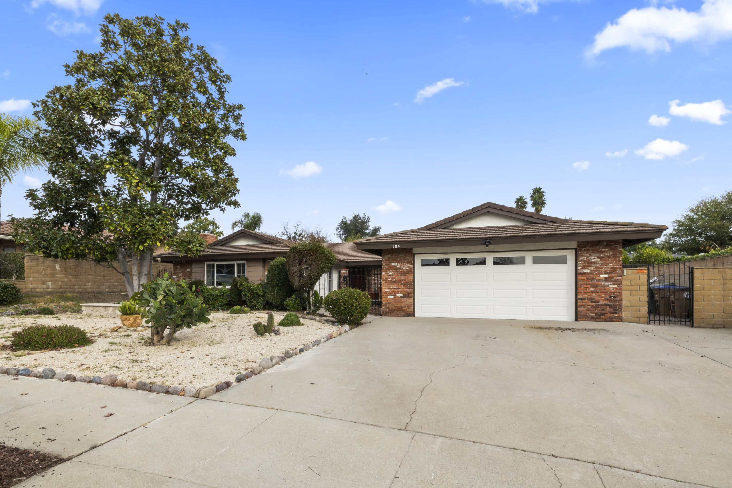 Single-story Claremont ranch home with a two-car garage and rock-lined drought-tolerant landscaping