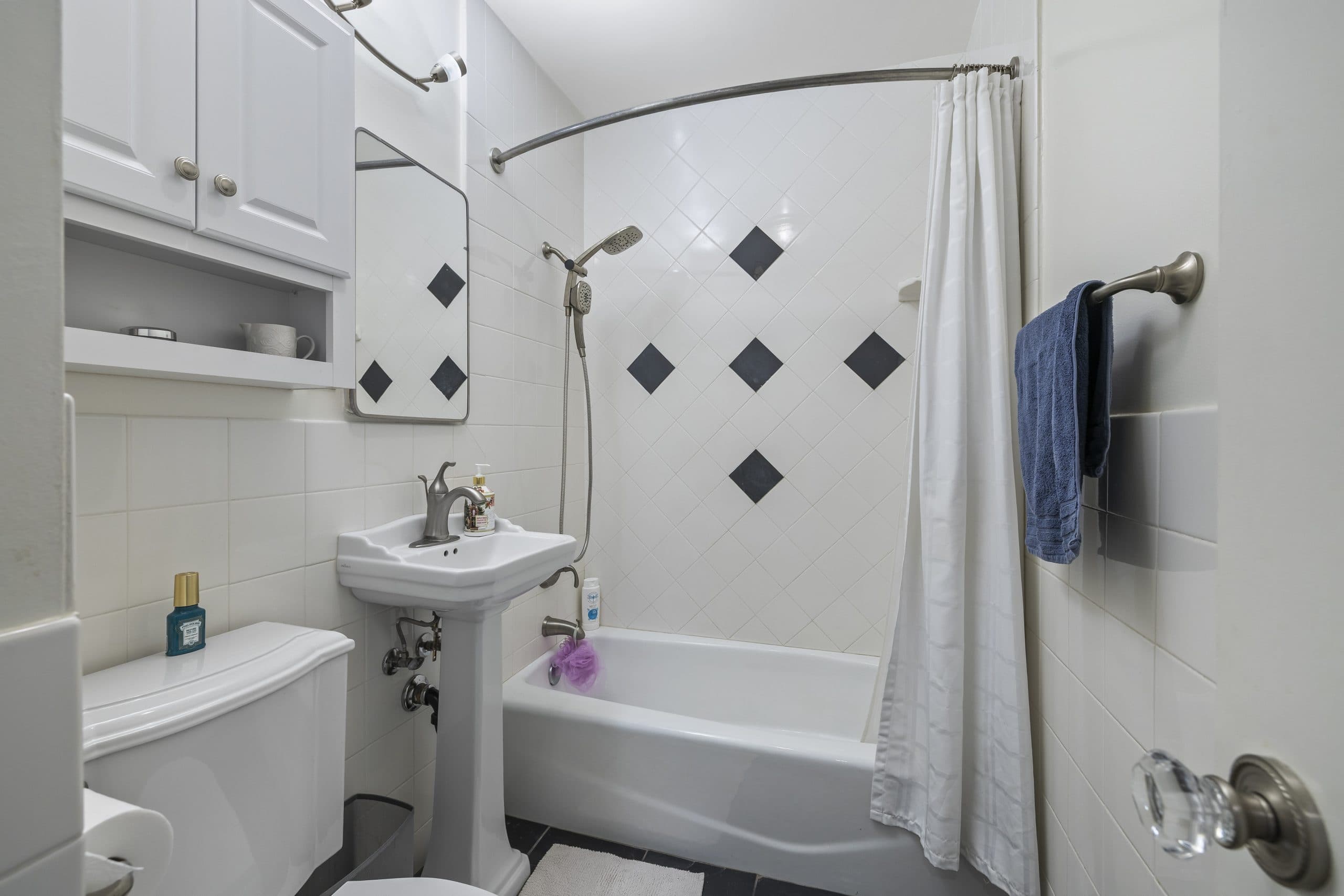 Compact bathroom with accent tile in a Claremont home