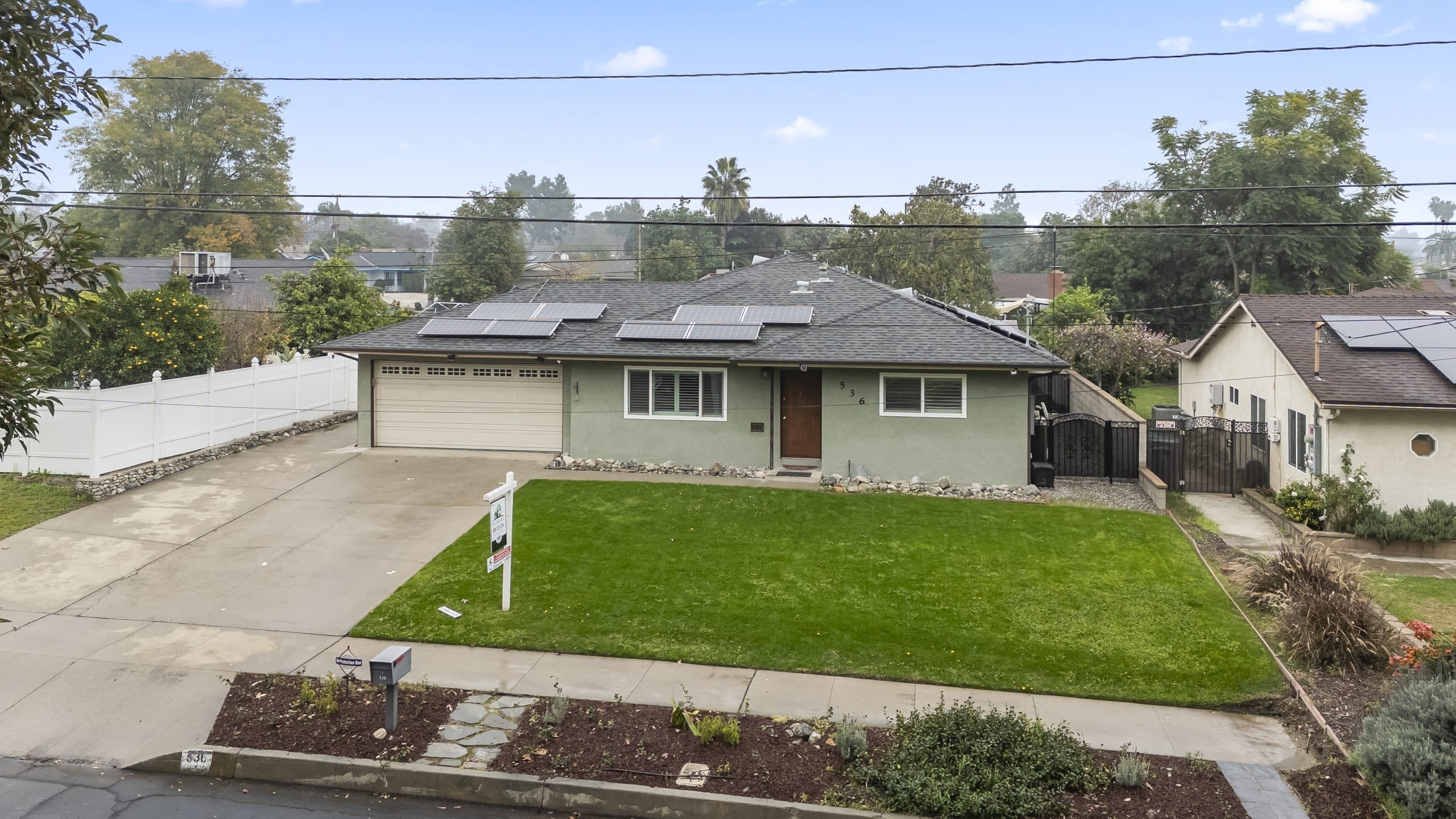 Elevated view of a Claremont home with neighboring houses along the street