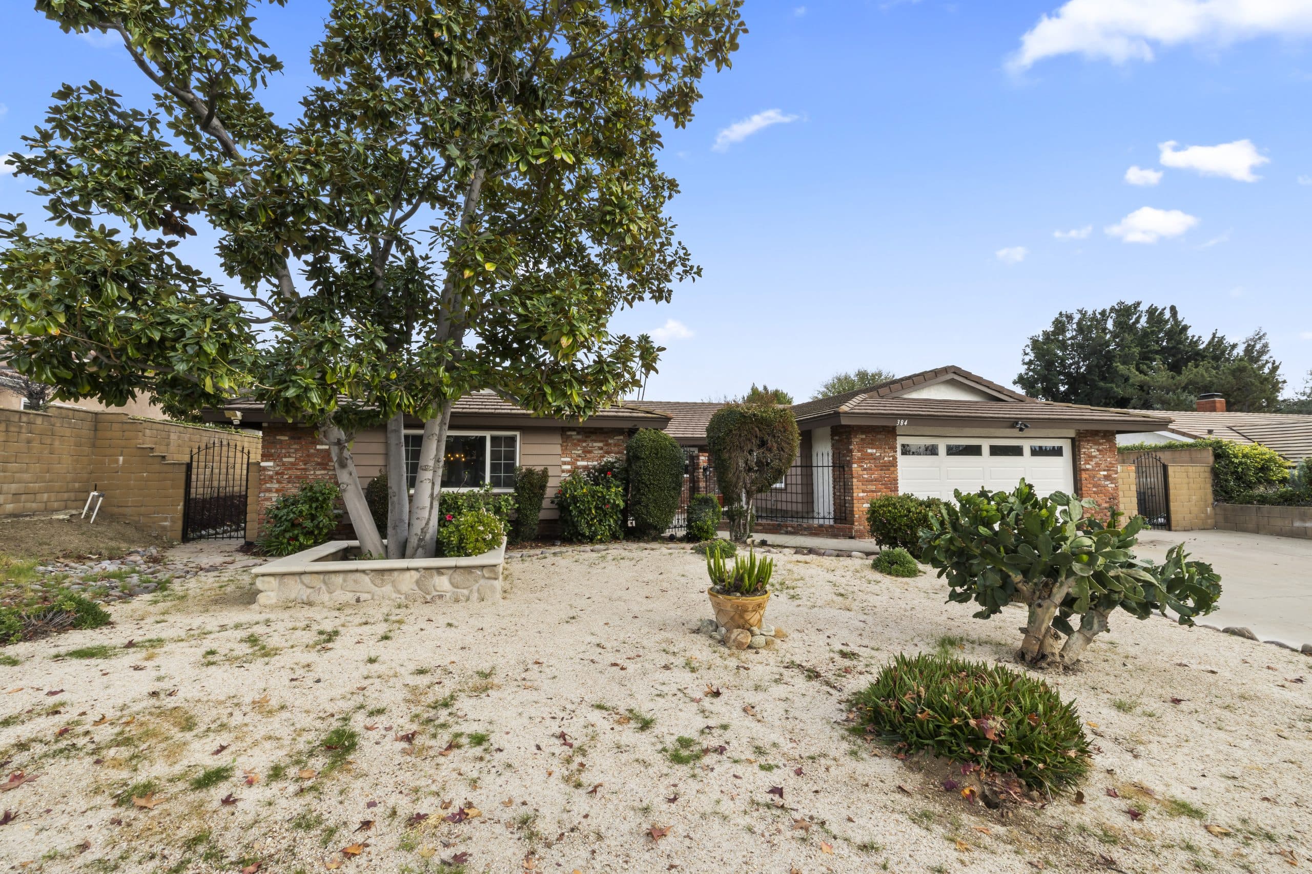 Front elevation of a brick-and-siding Claremont ranch home, the structure a homeowner insurance policy covers