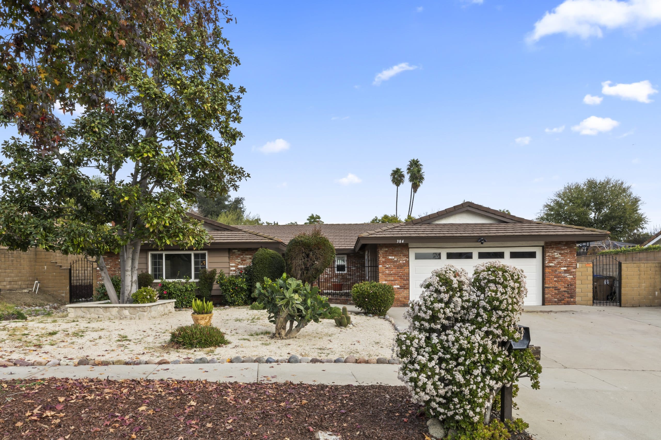 Established brick ranch home with mature tree on a Claremont street