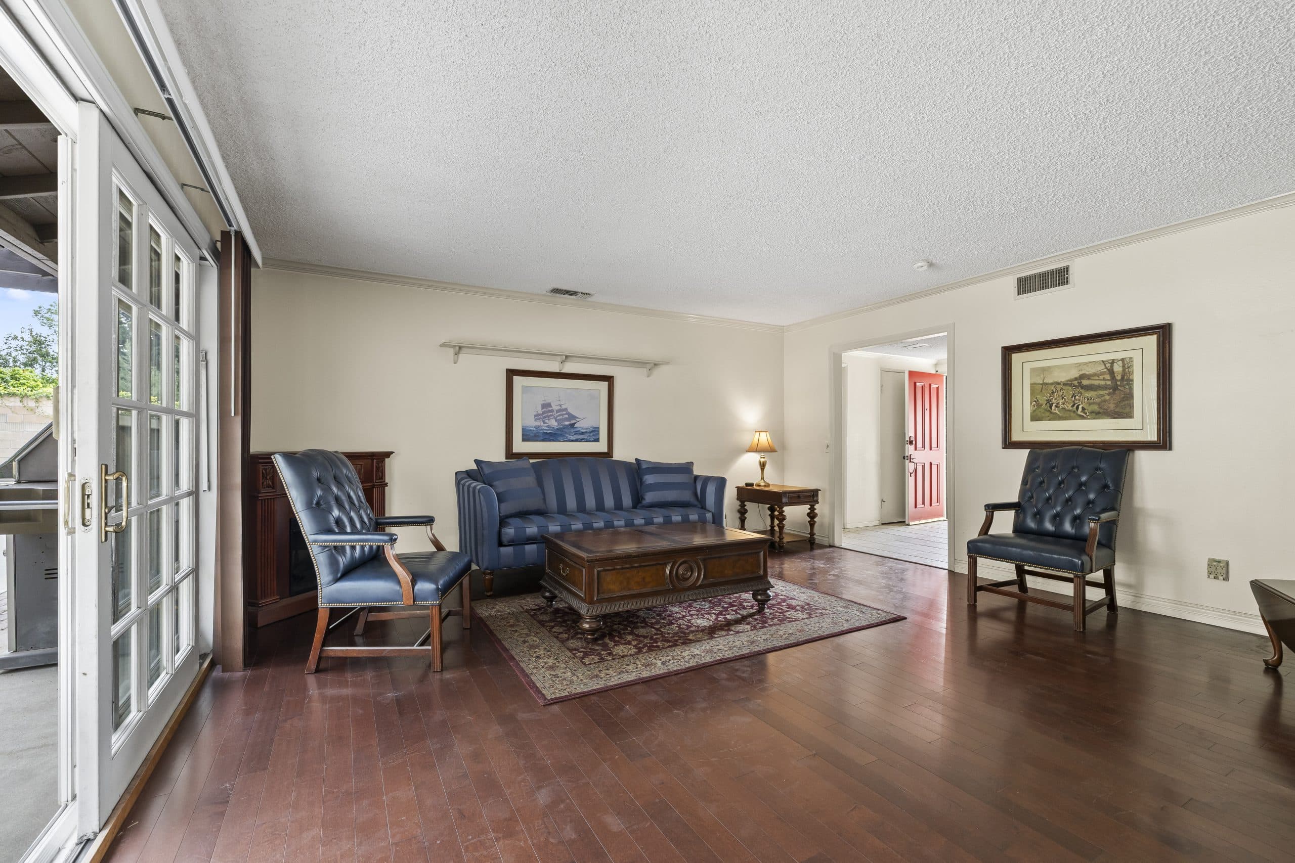 Matched navy wingback chairs by the front hallway of a Claremont home