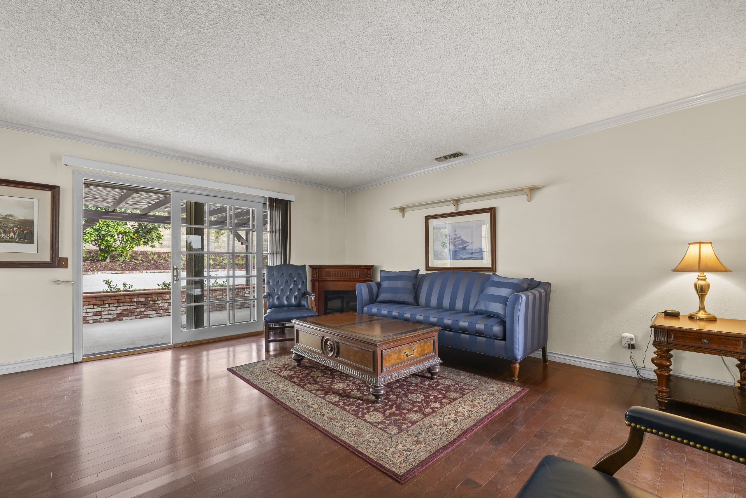 Lamplit Claremont living room with a door open to the garden