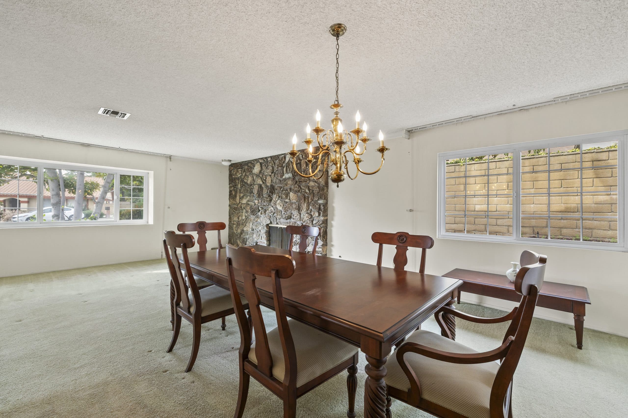 Formal Claremont dining room with mahogany table beneath a brass chandelier