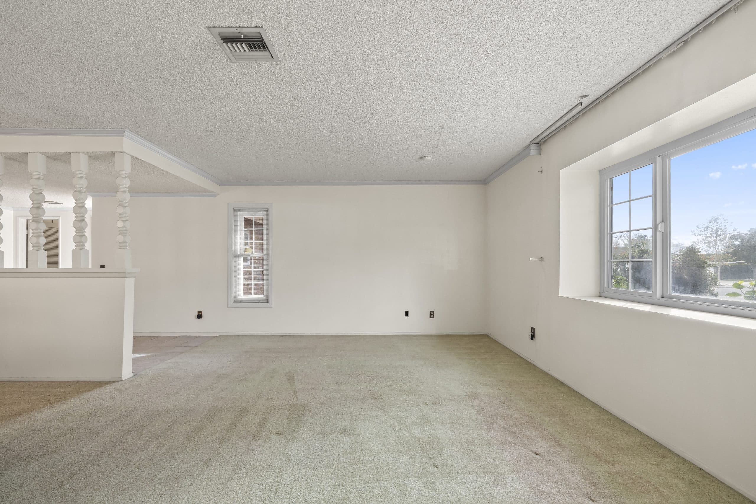 Emptied room with bright window in a Claremont home during a transition