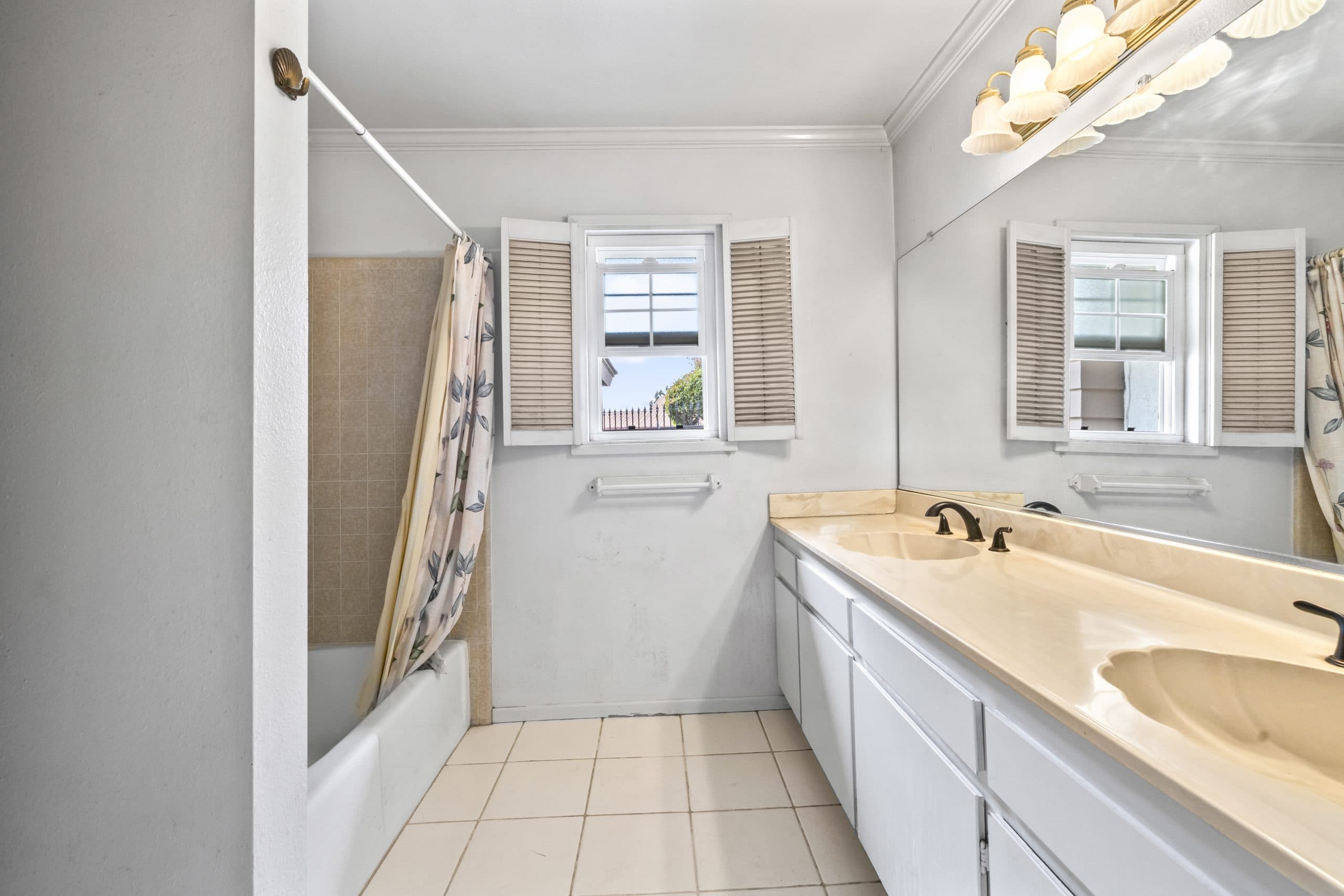 Hall bathroom with a shuttered window in a Claremont home