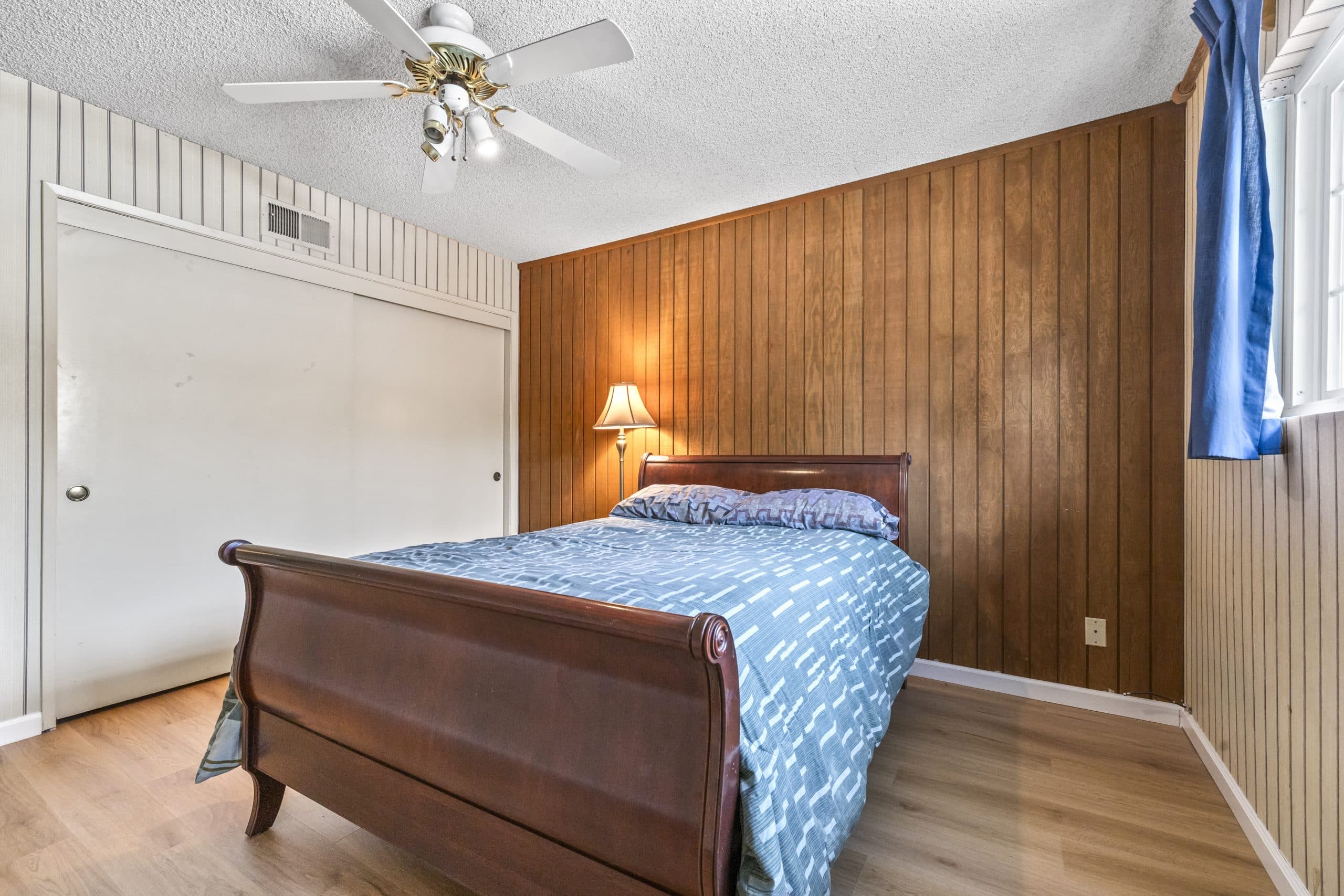 Warm lamp-lit ground-floor bedroom in an established Claremont home