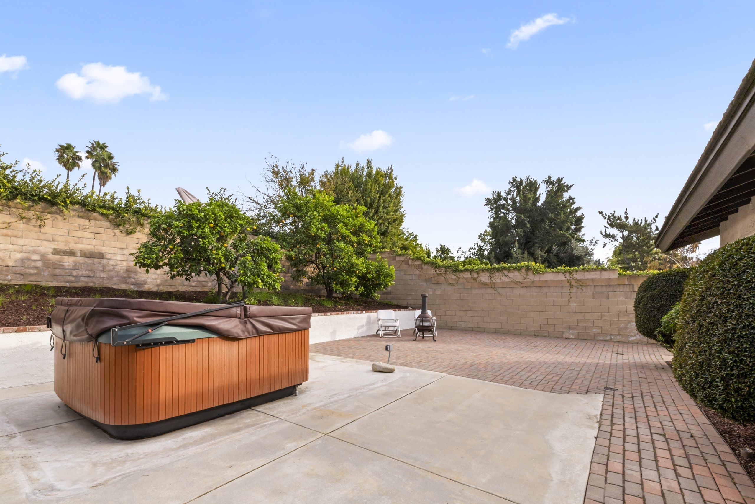 Covered spa and equipment on the brick patio of a Claremont home